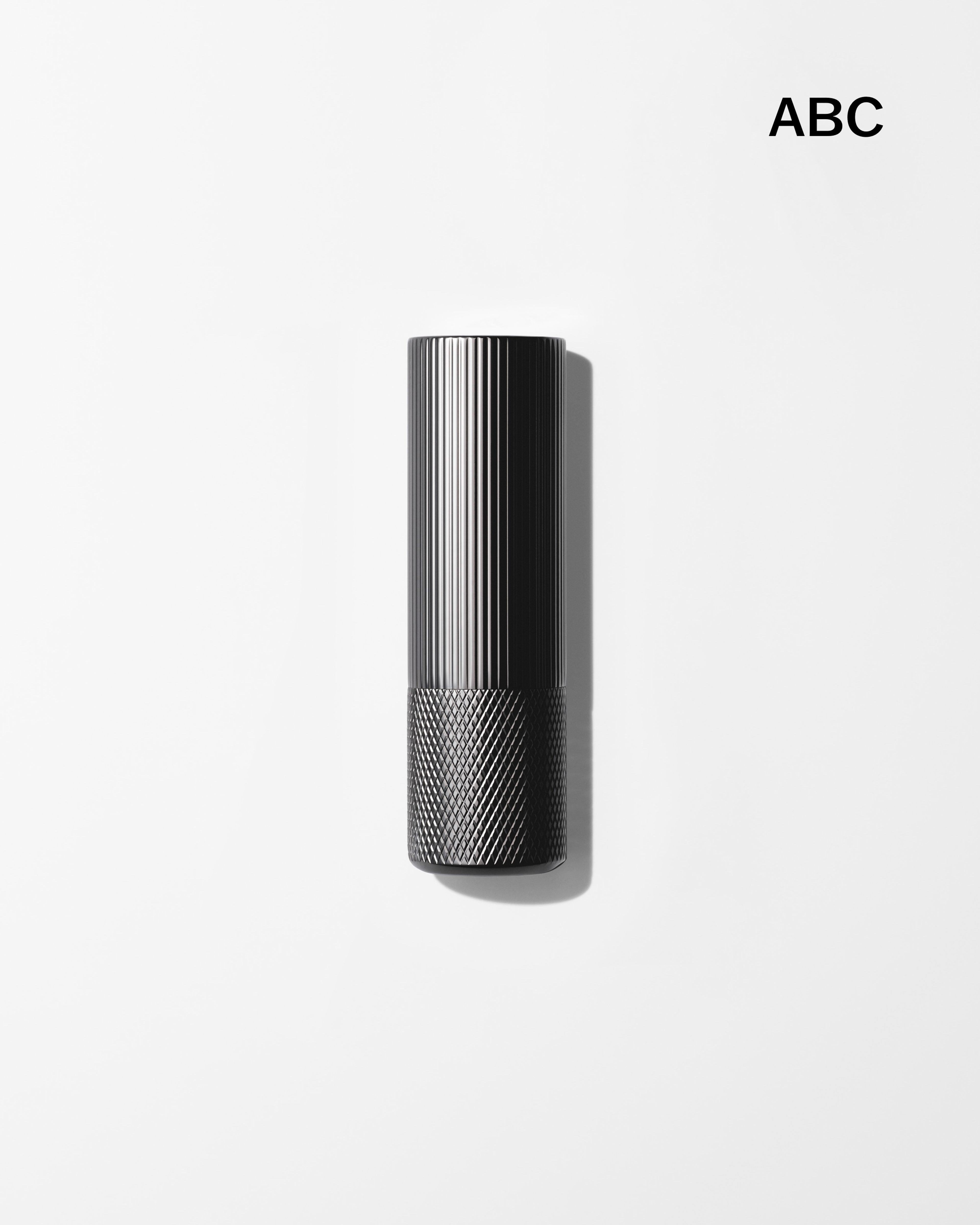 Mens lip balm laying on a grey surface