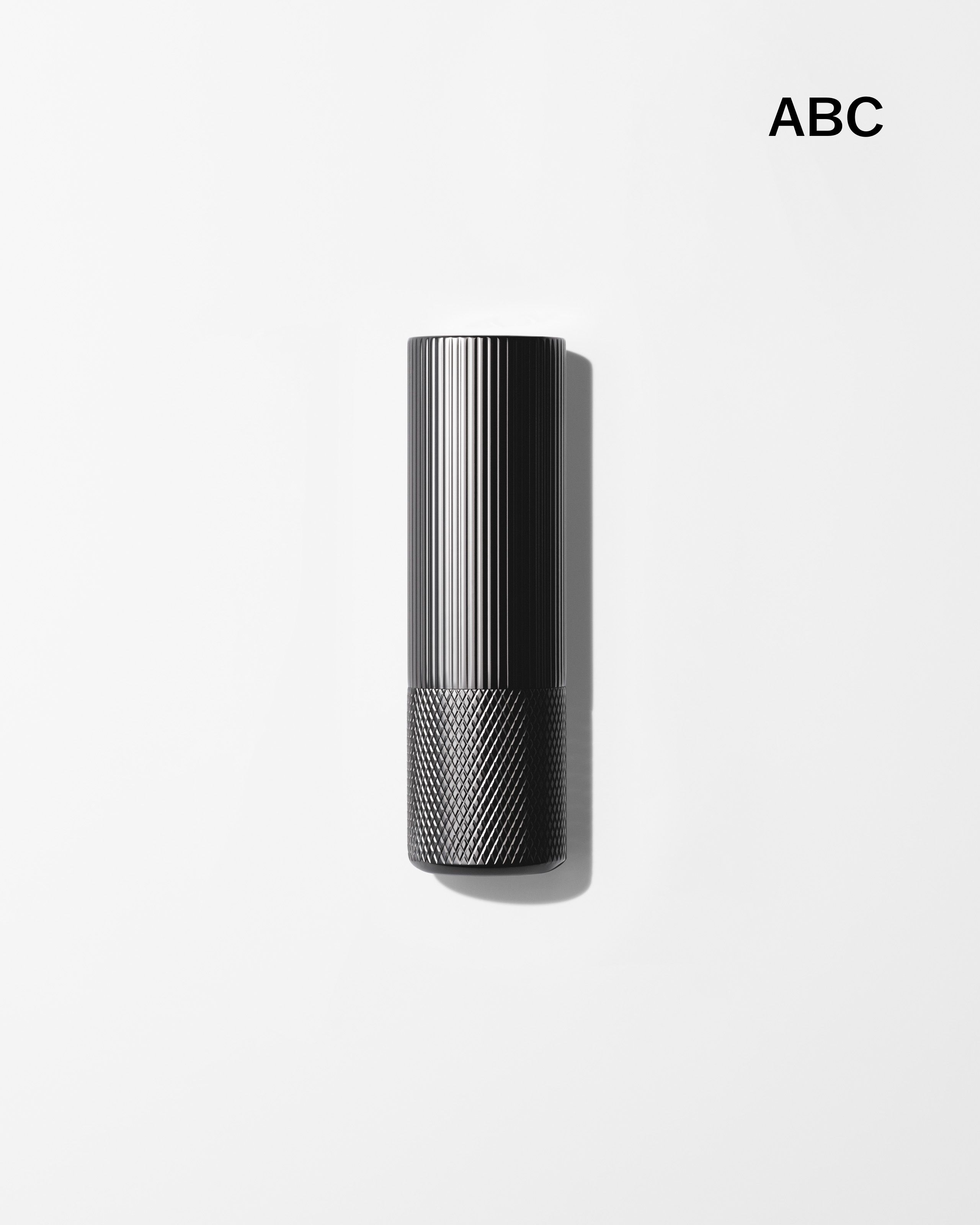 Soothing Lip Balm laying on a grey surface