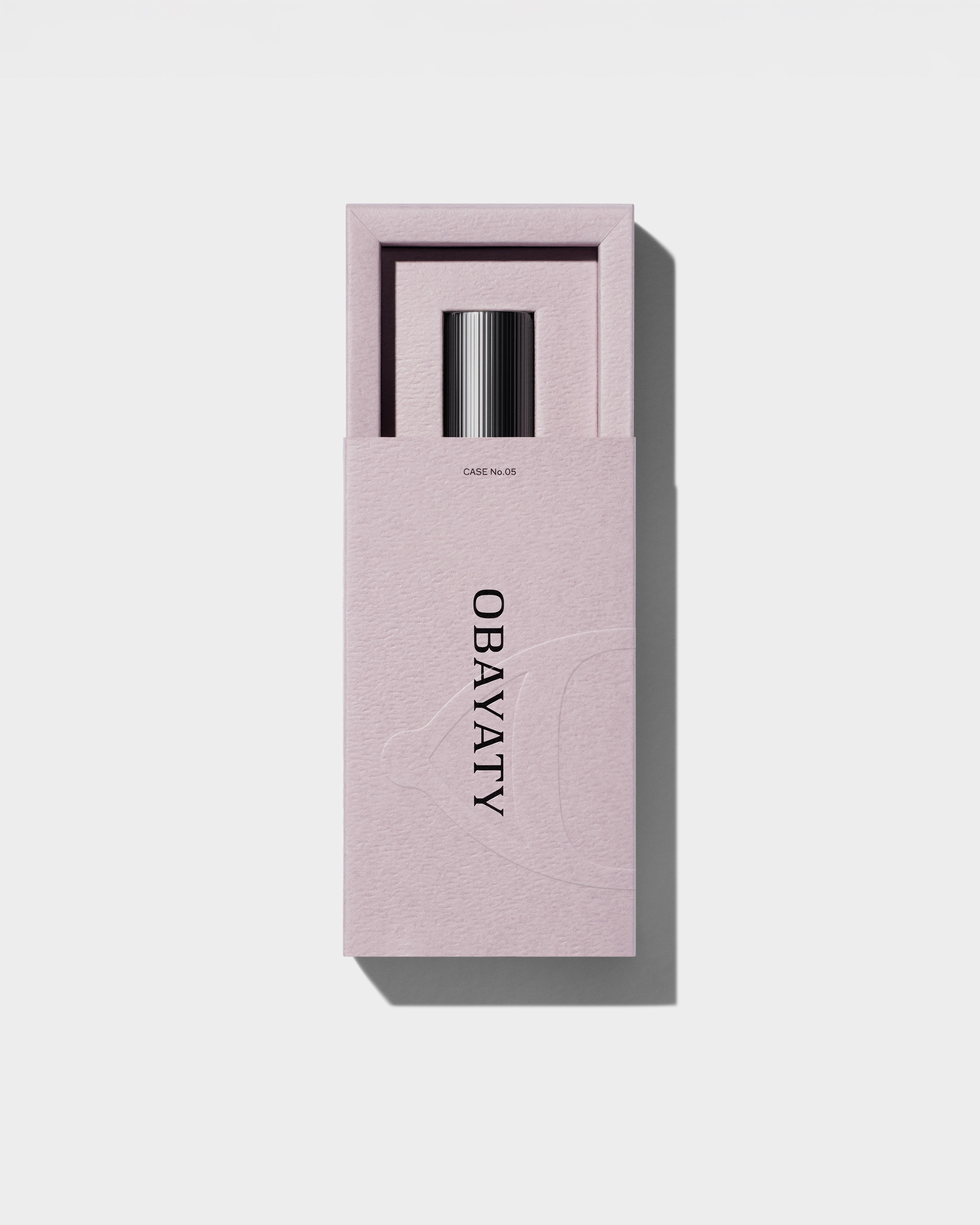 Open Lip Balm packaging laying on a grey surface