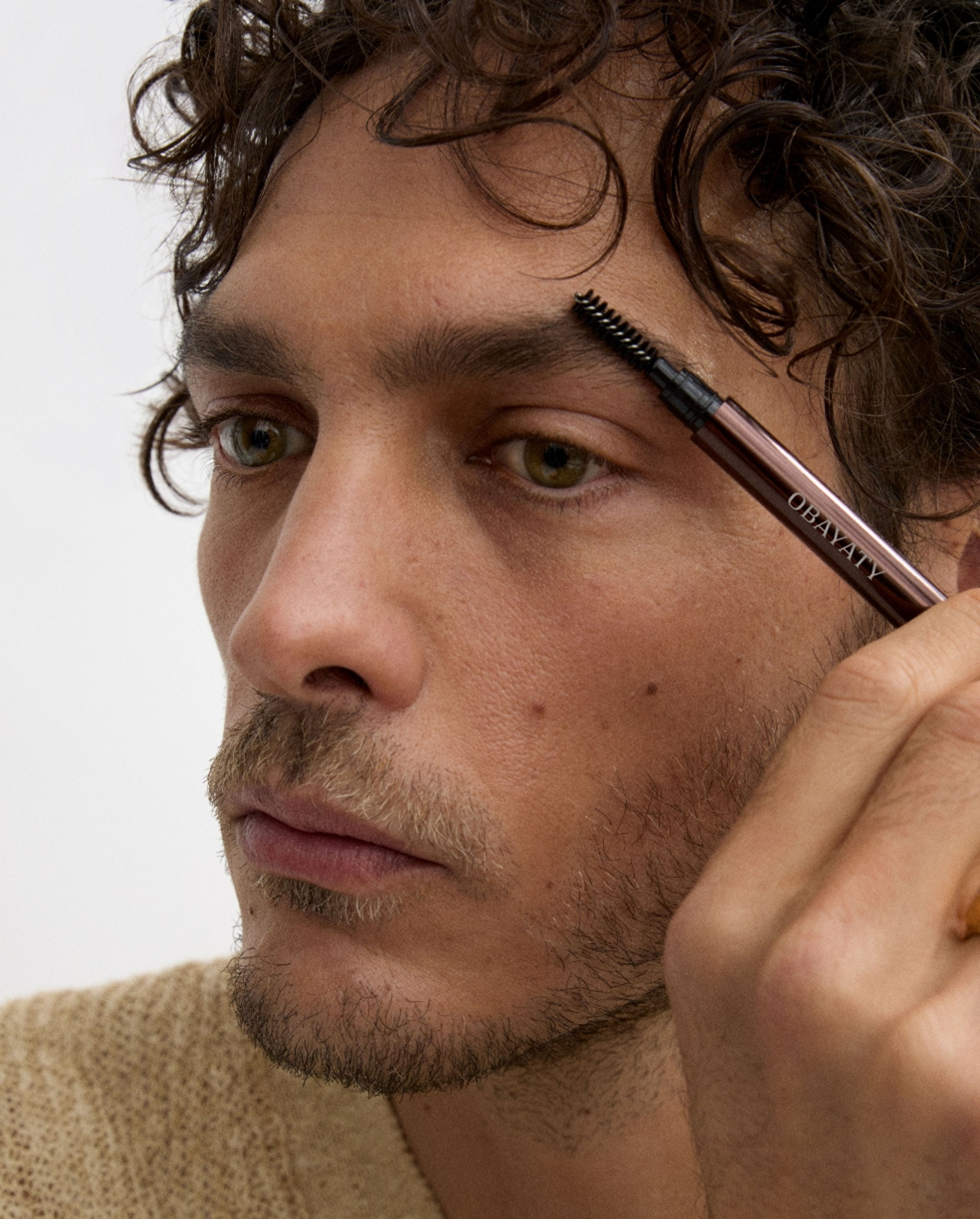 Man brushing his eye brow