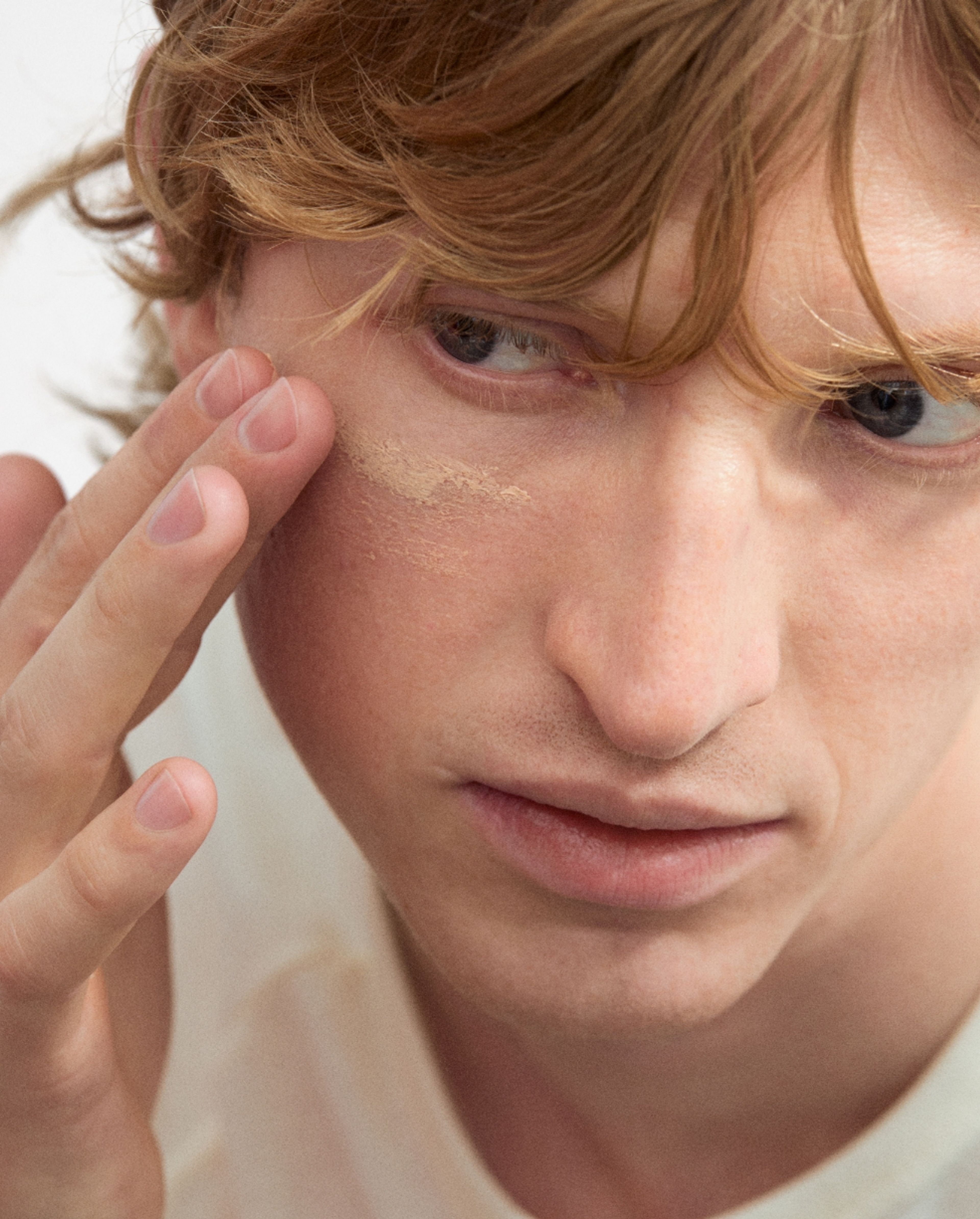 Man applying tinted moisturizer
