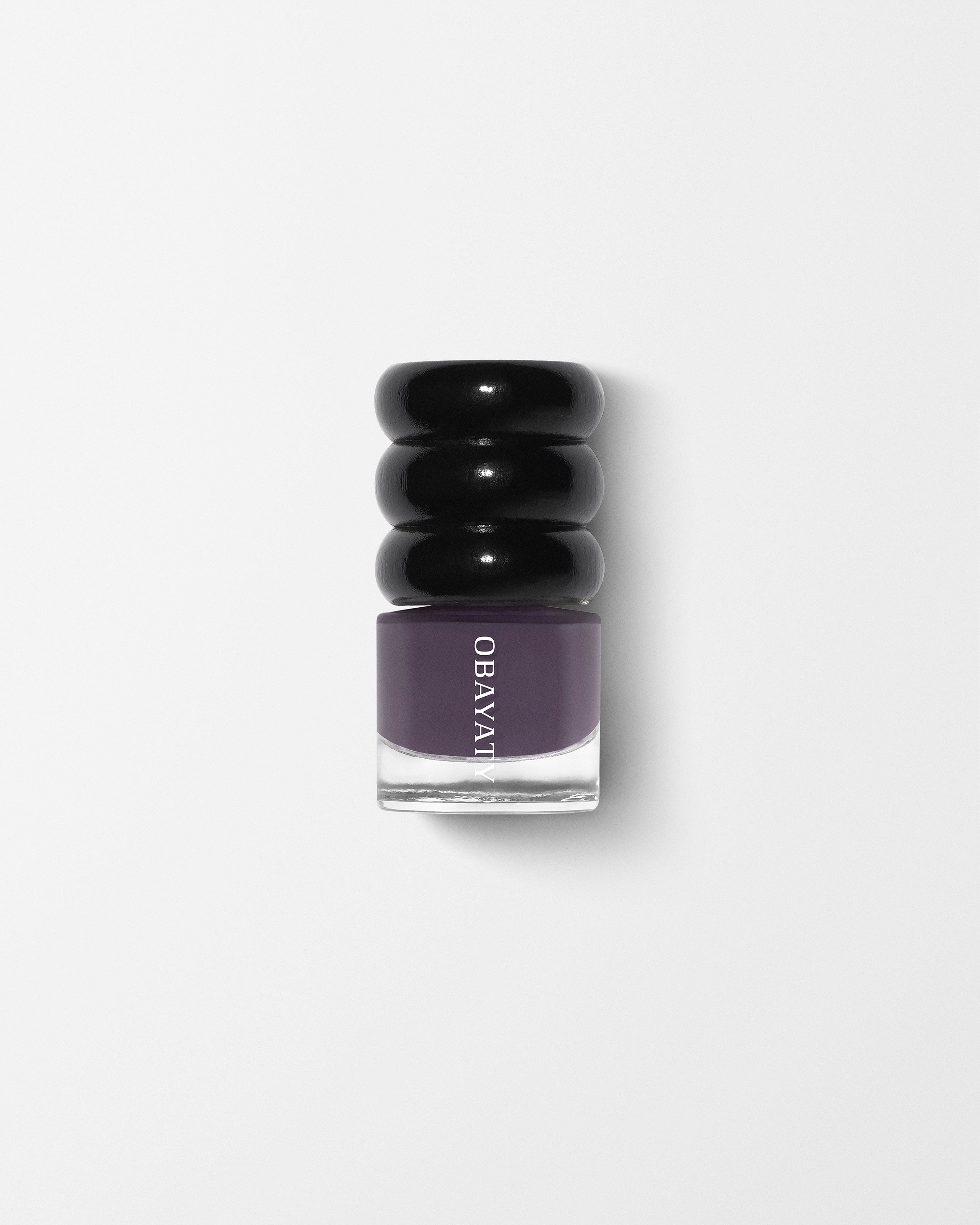 Nail polish Violet Dusk laying on white surface
