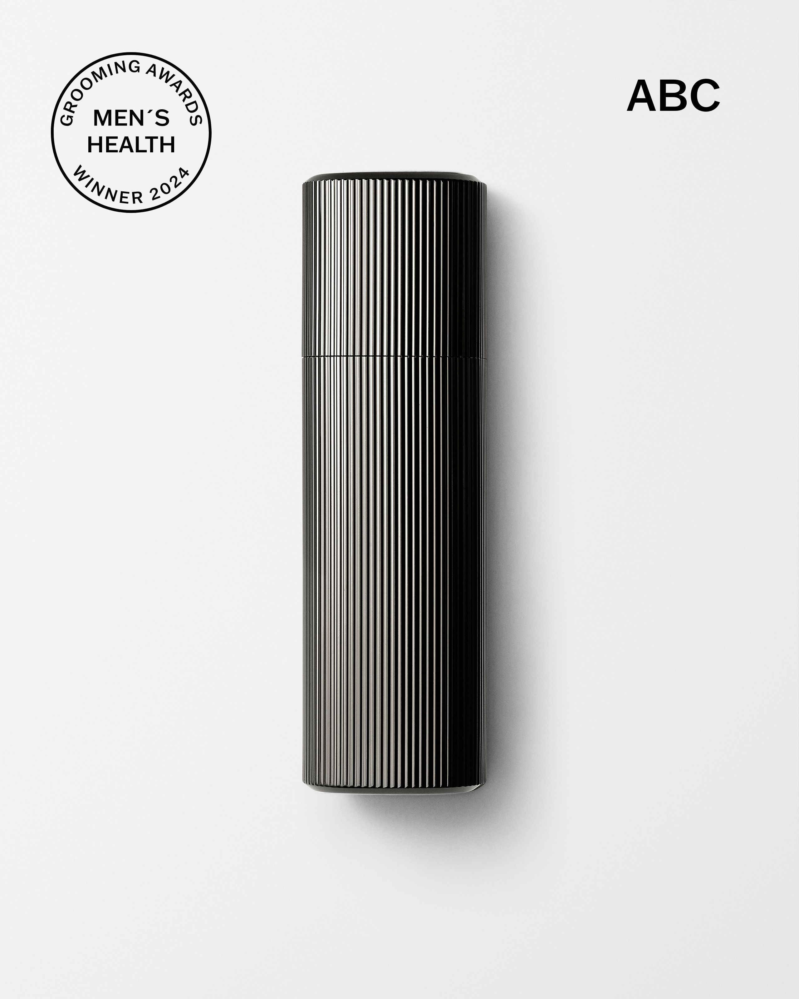 Men's tinted moisturizer and concealer laying on a grey surface