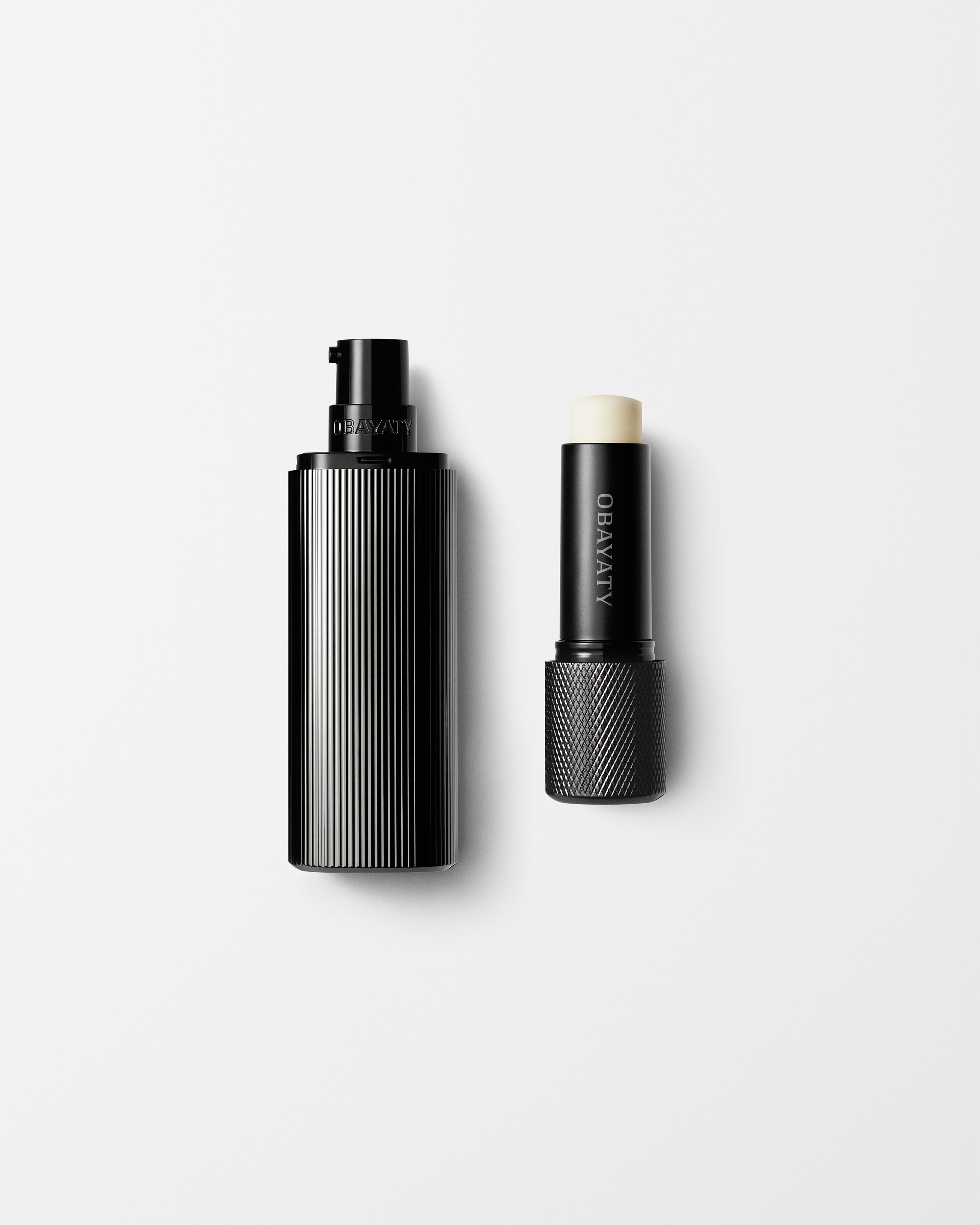 Men's moisturizer and lip balm laying on a grey background