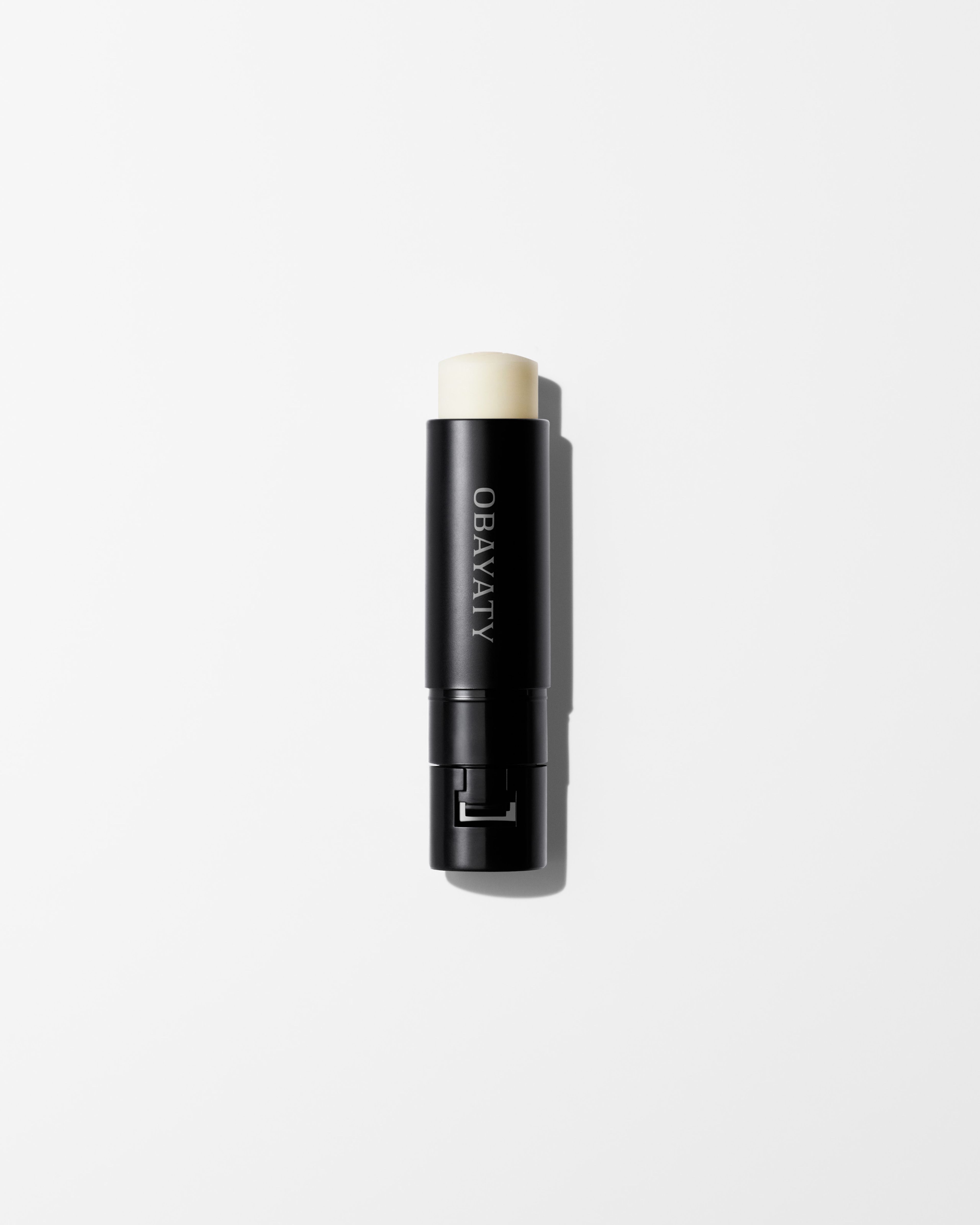 Soothing Lip Balm refill laying on a grey surface