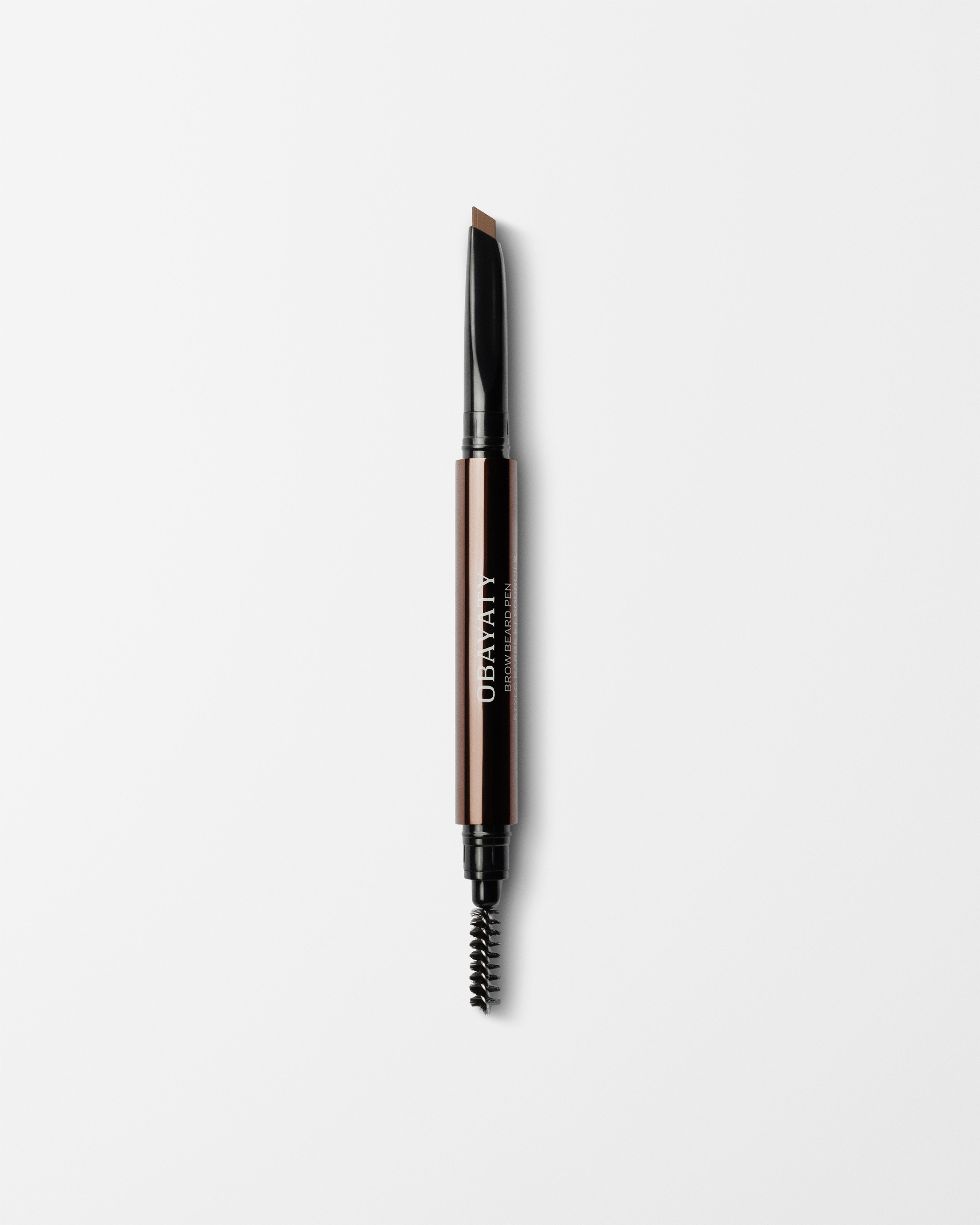 Brow Beard Pen laying on a grey background