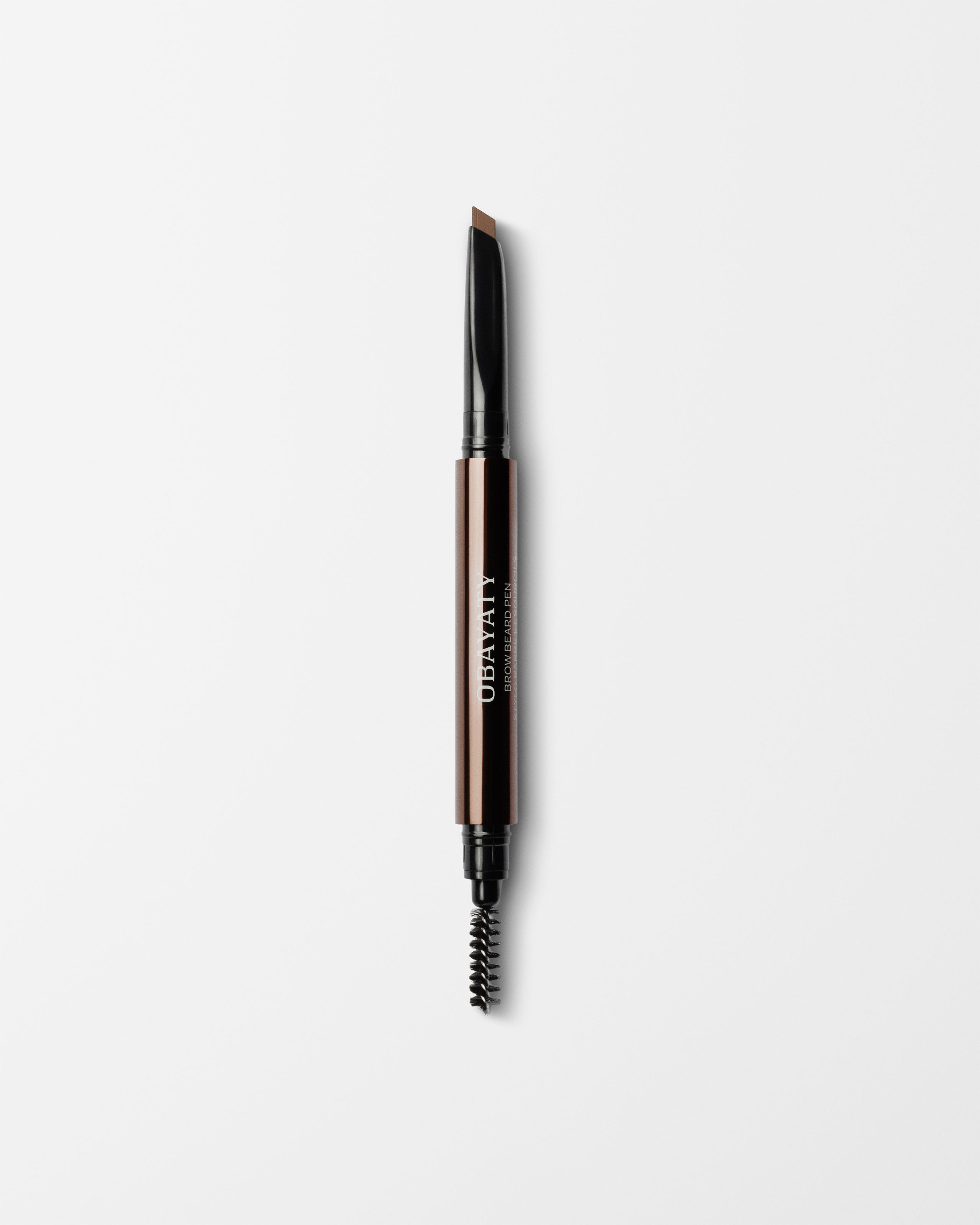 Brow Beard Pen laying on a grey background