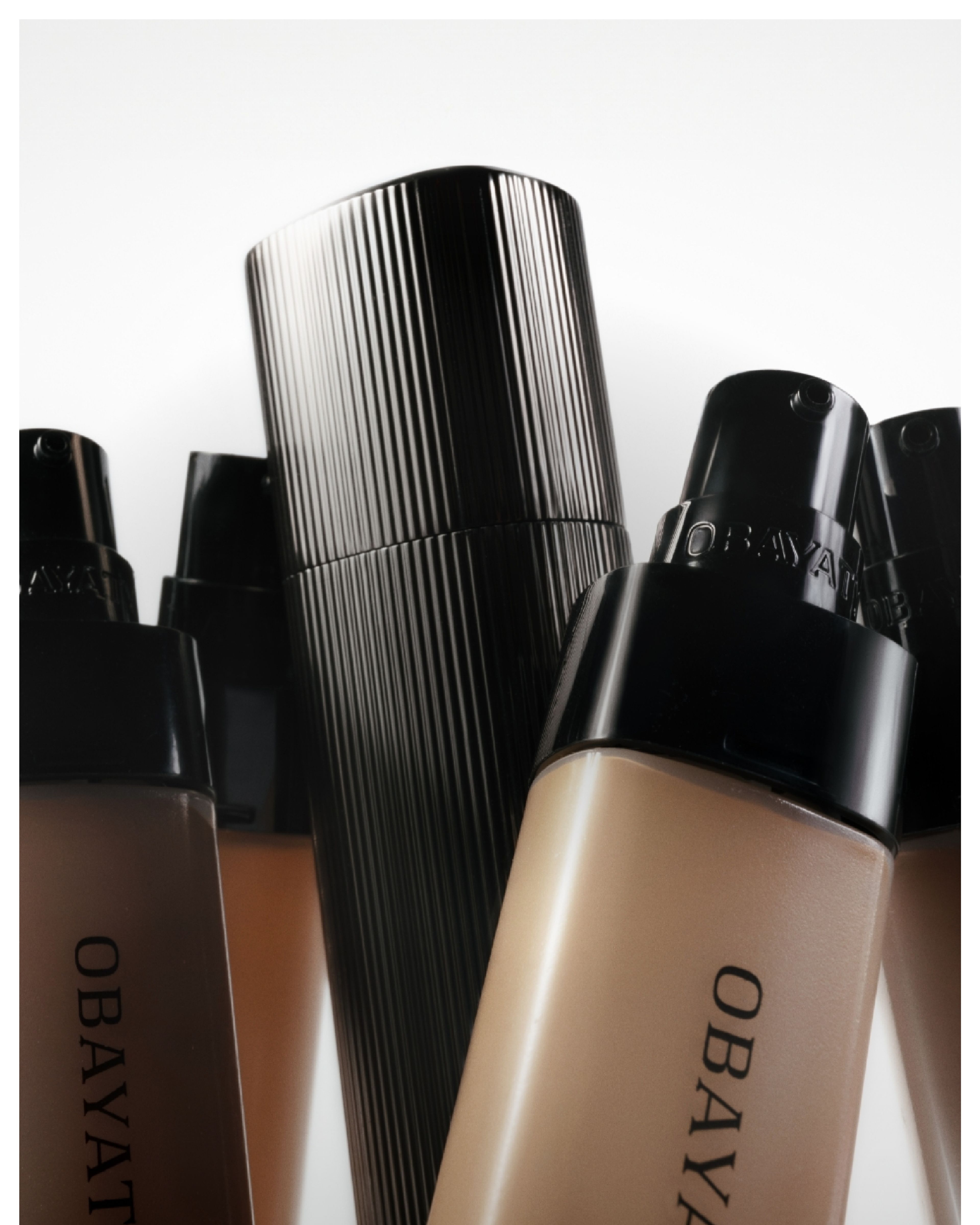 Several tinted moisturizer refills leaning agains a metal case