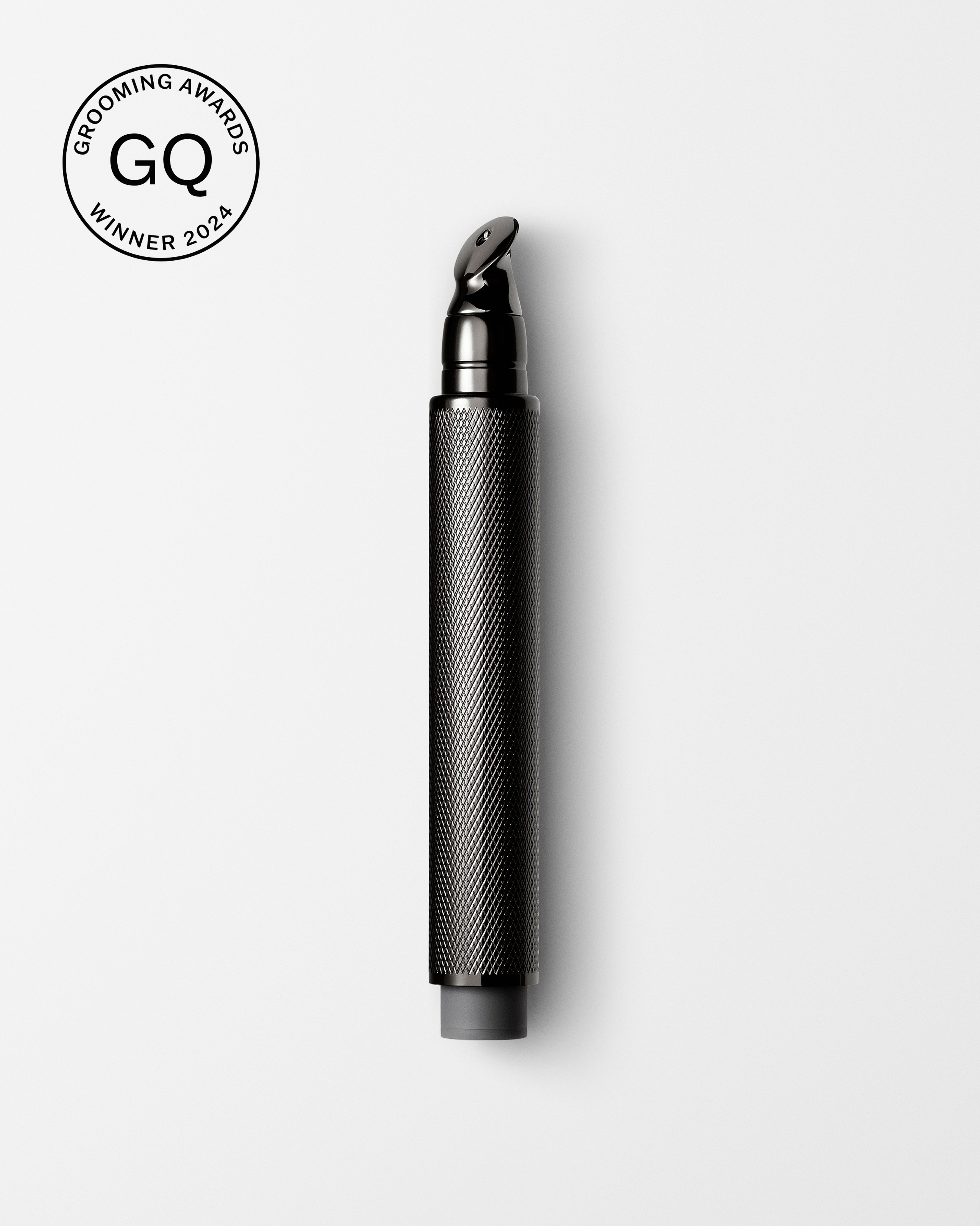 Men's tinted eye cream laying on a grey surface