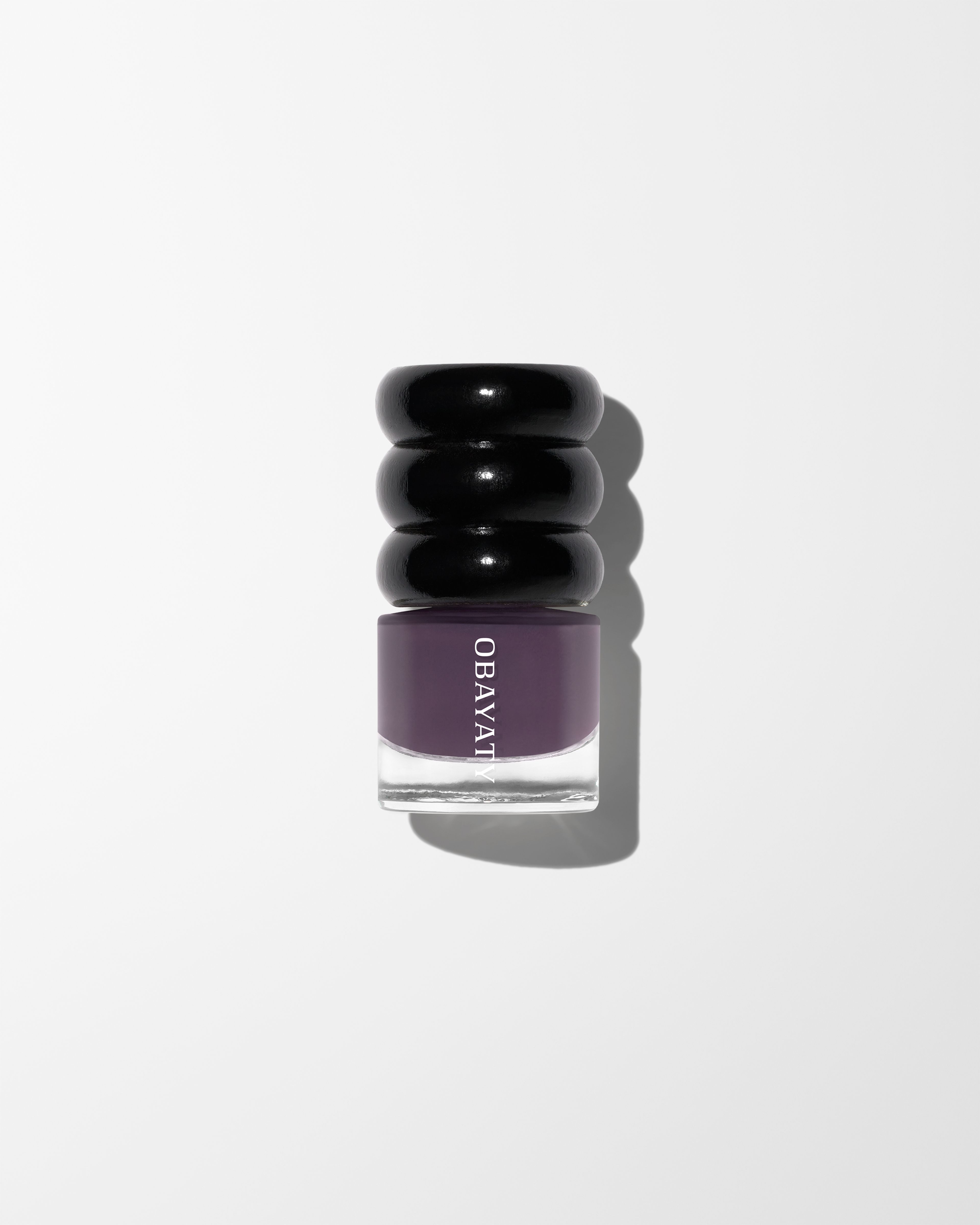 Nail polish Violet Dusk laying on white surface