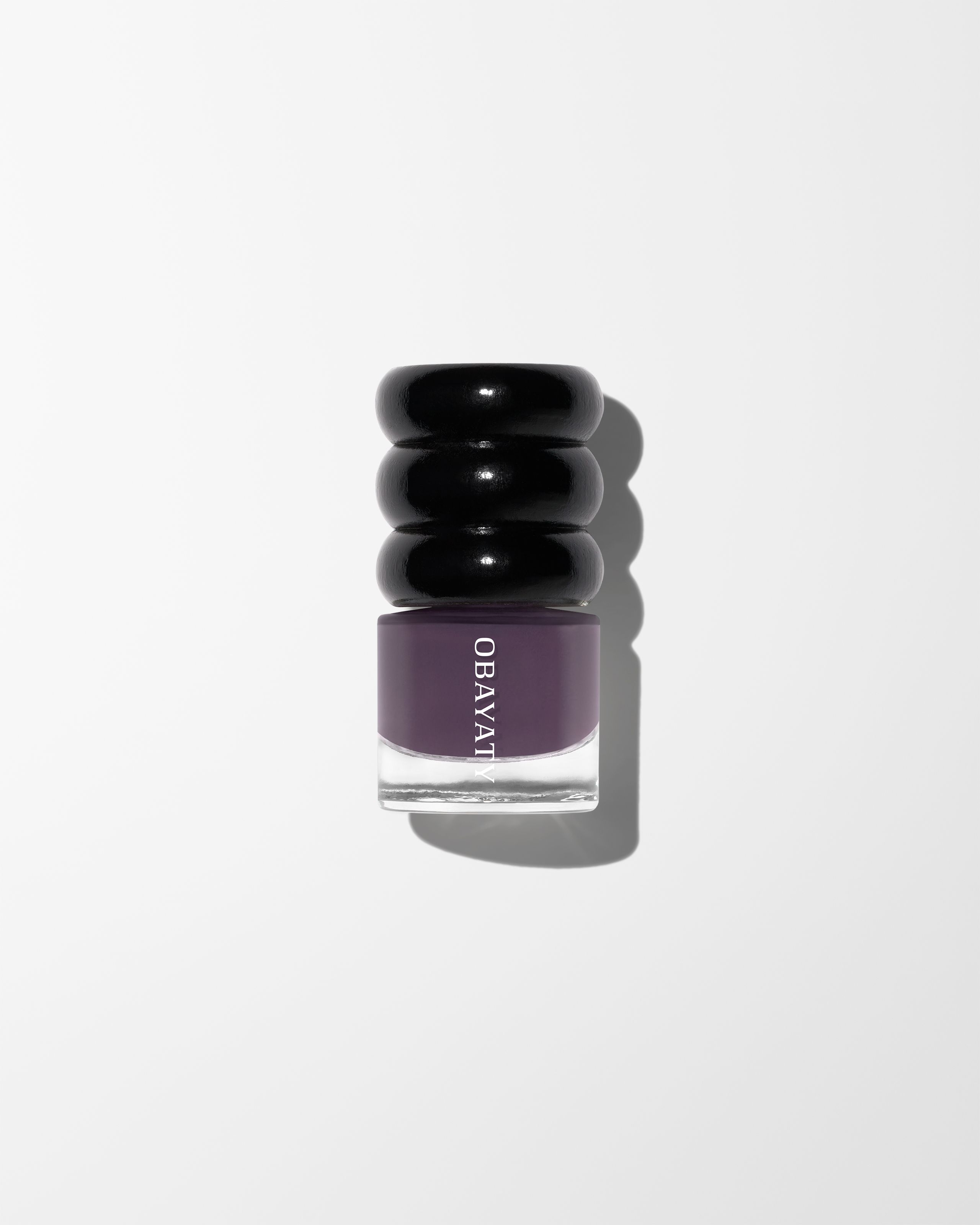 Nail polish Violet Dusk laying on white surface