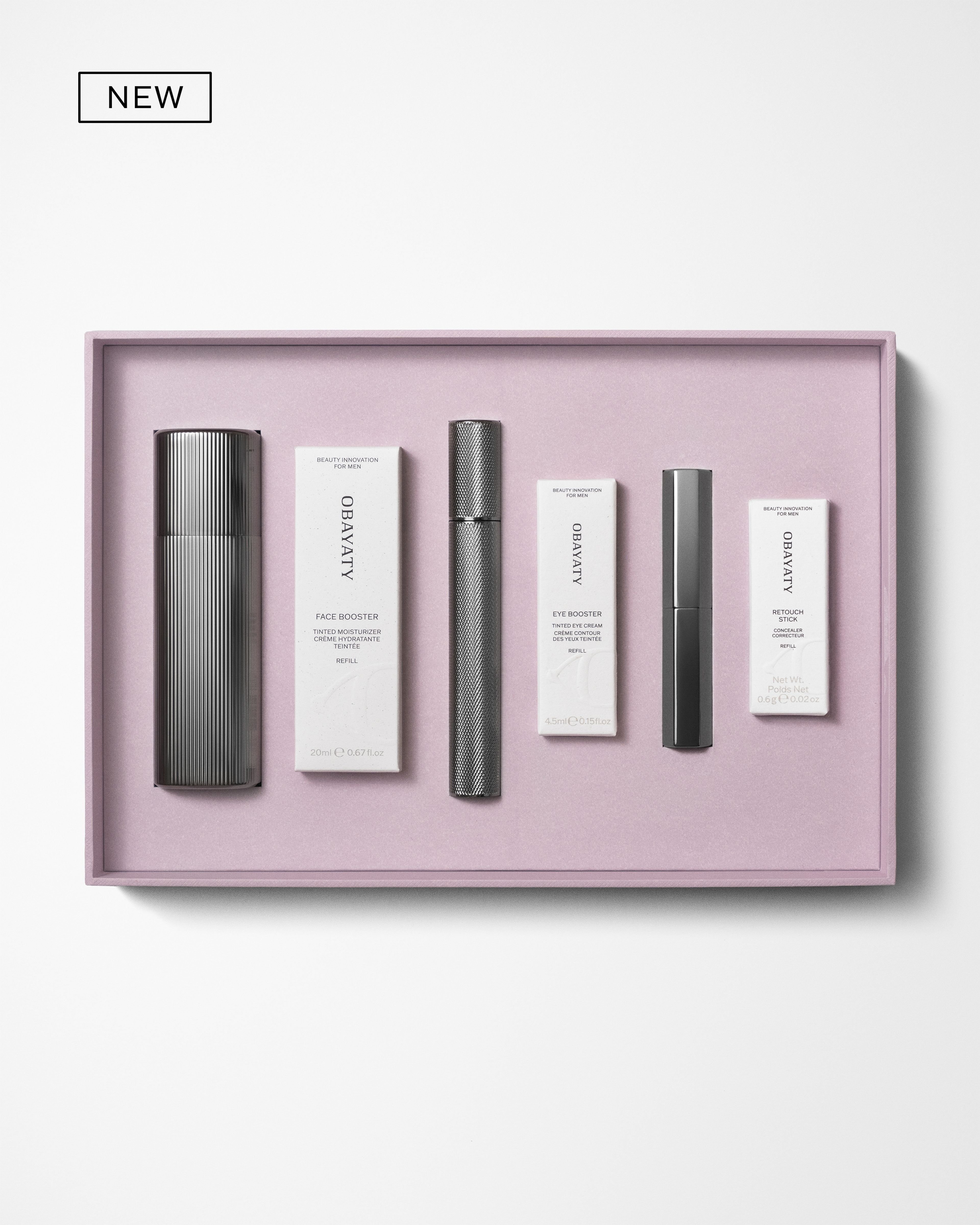 Men's make up kit laying on a grey background