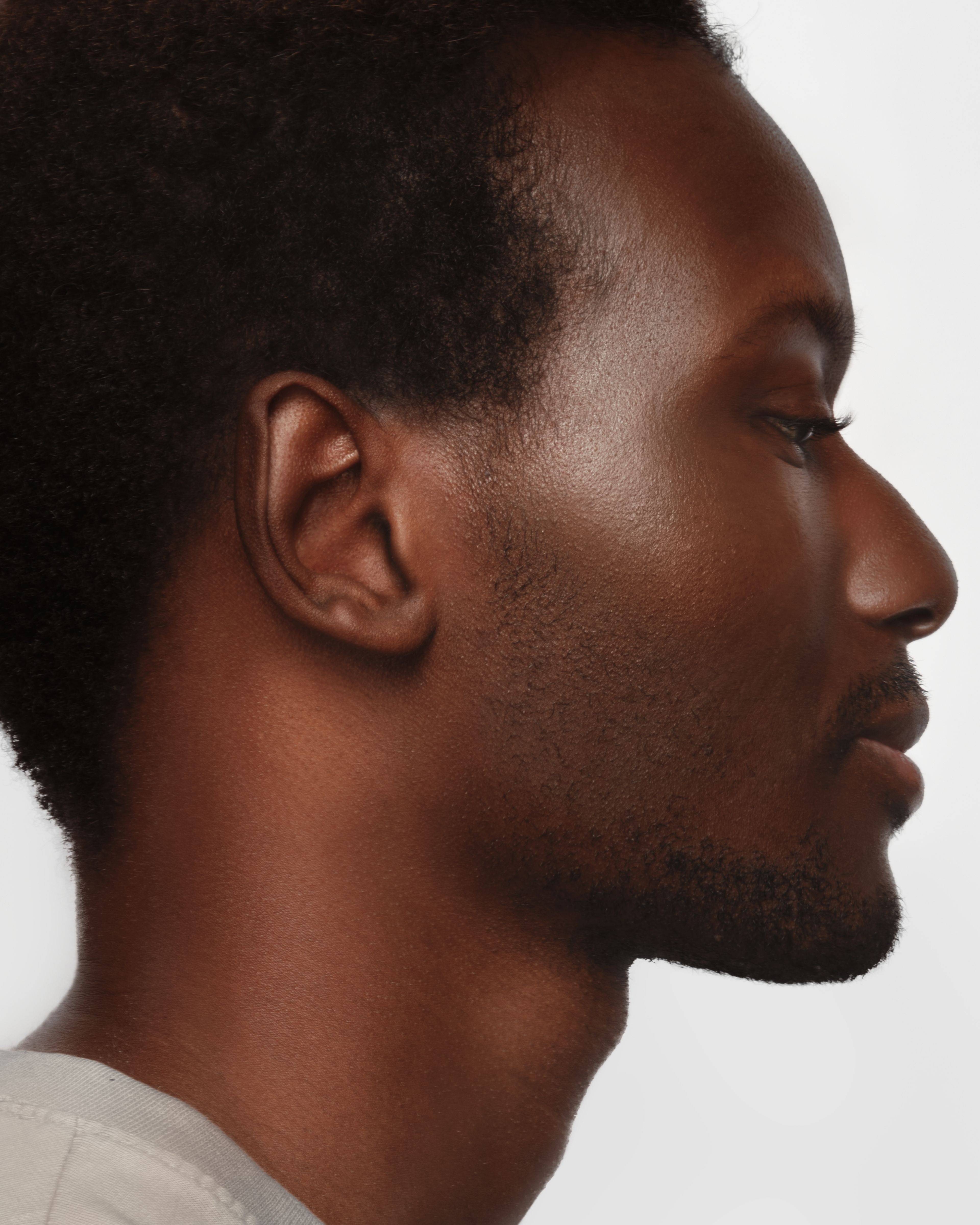 Man in profile in front of a white background