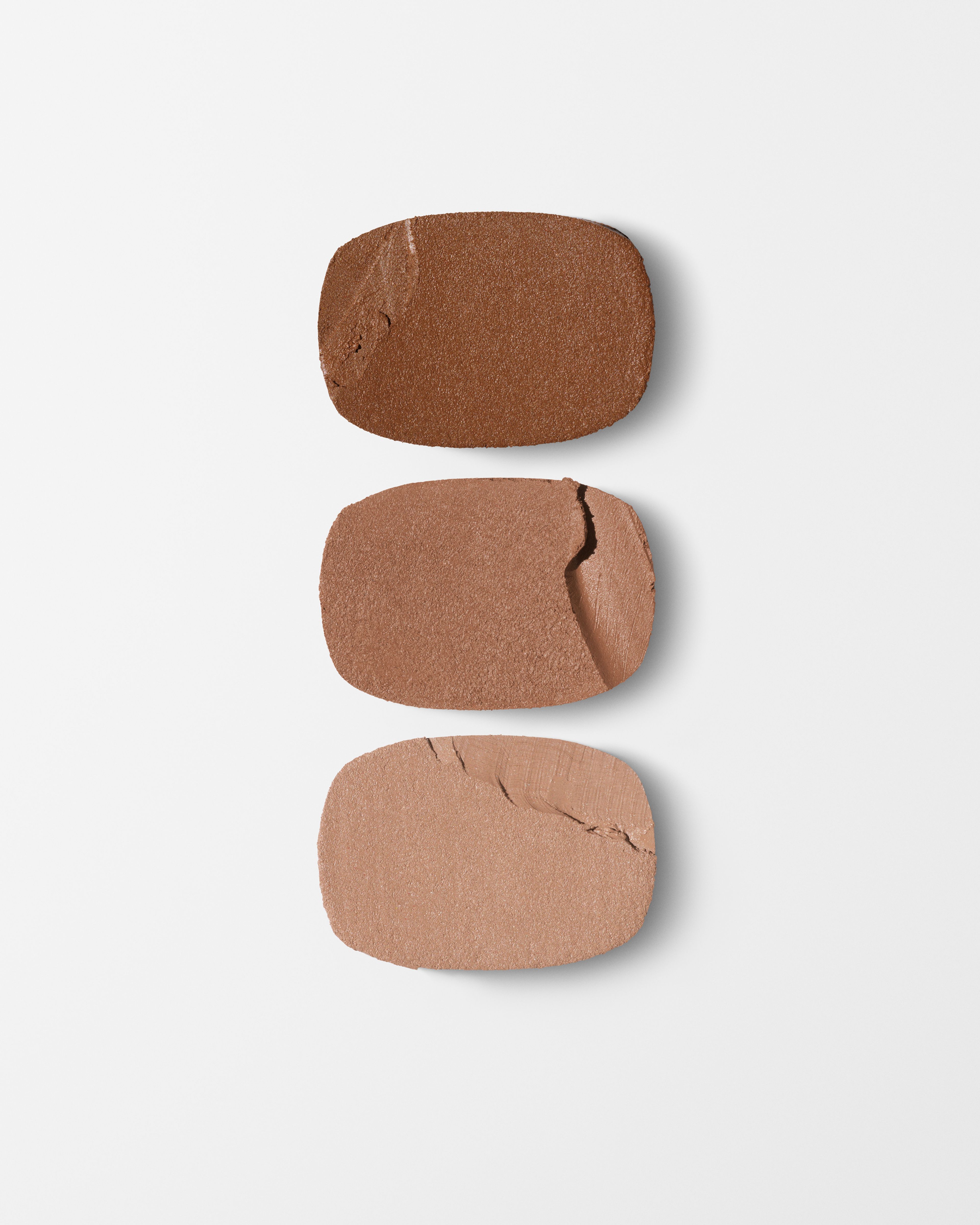 Bronzer refill laying on a grey surface
