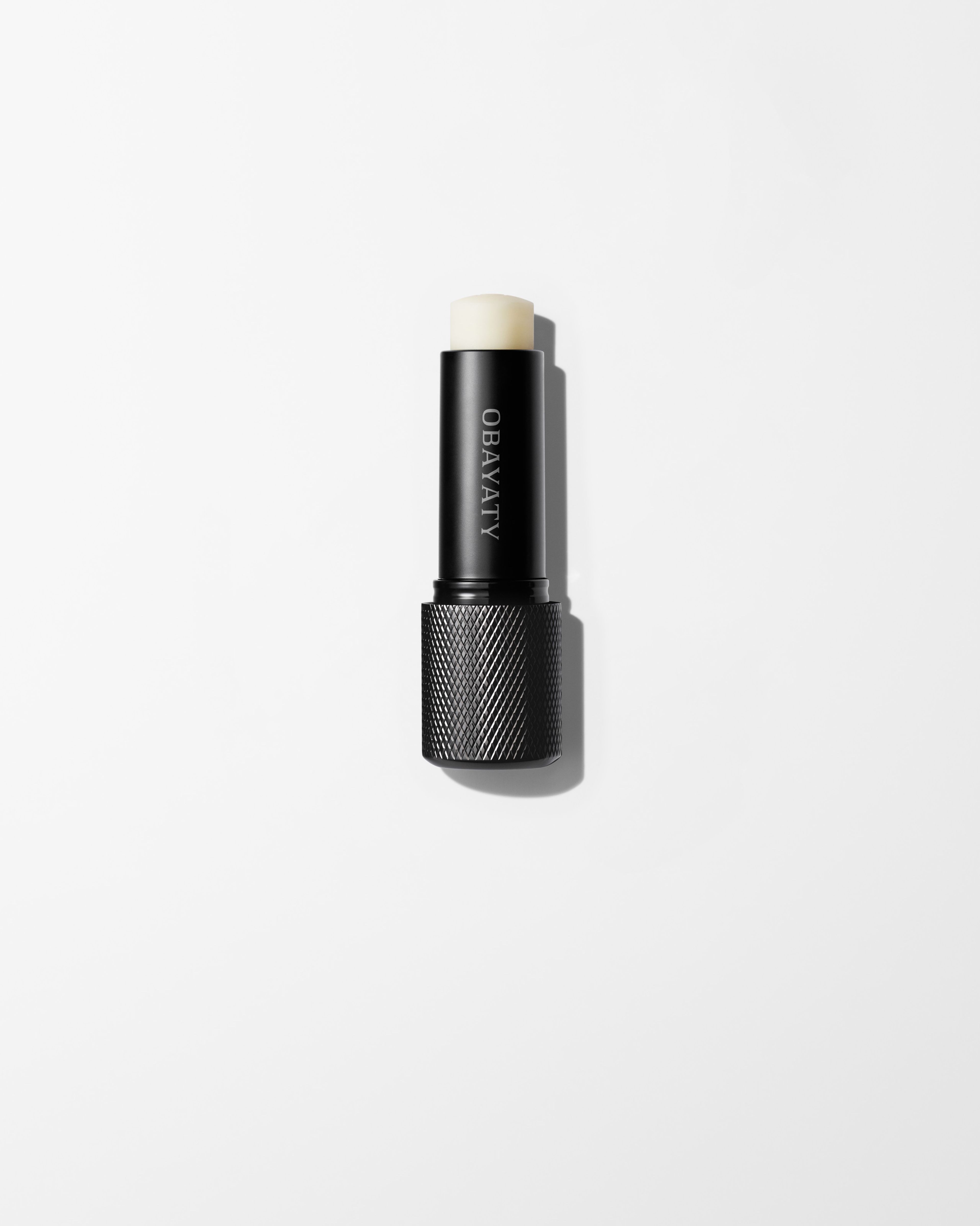 Soothing Lip Balm laying on a grey surface