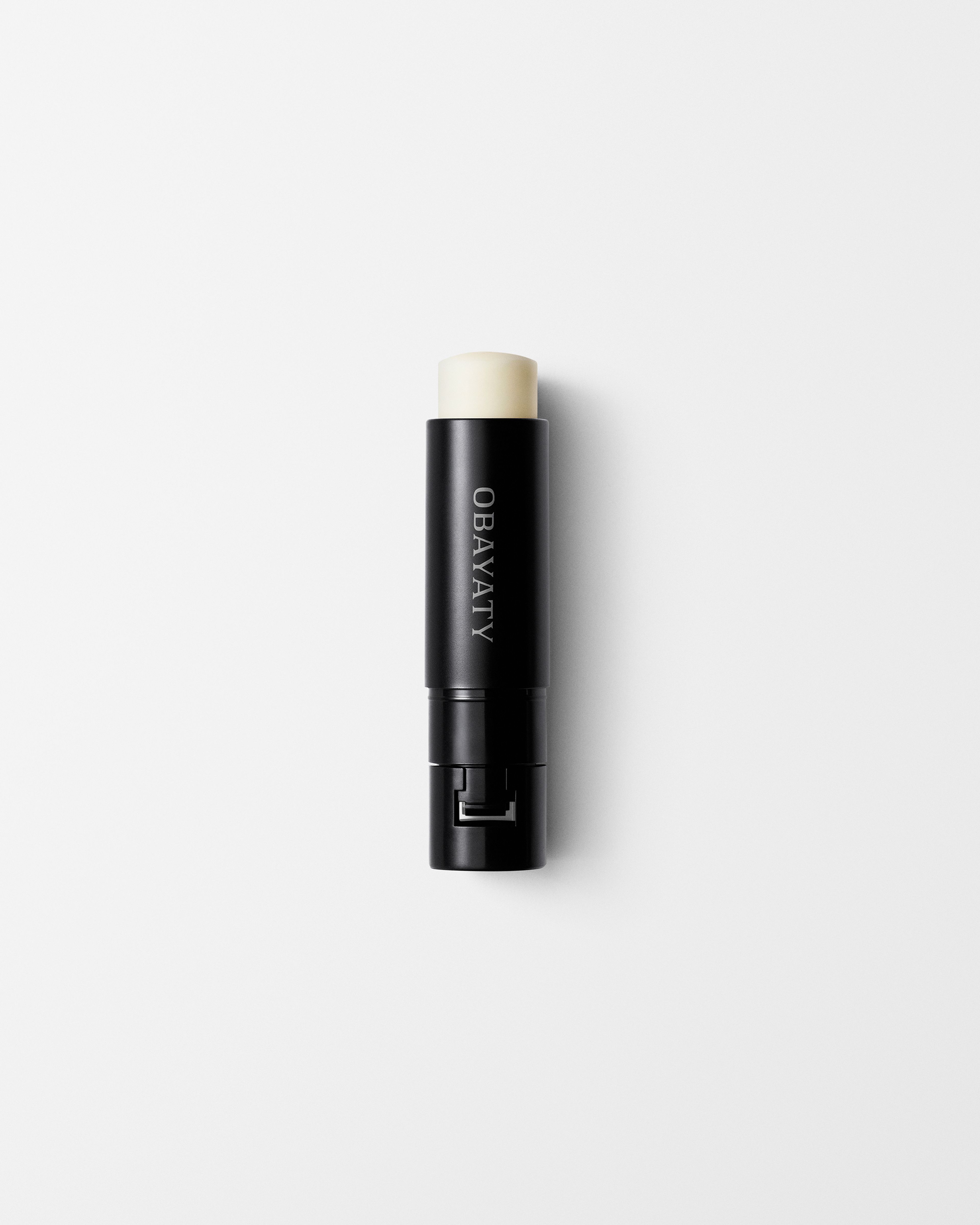 Soothing Lip Balm refill laying on a grey surface