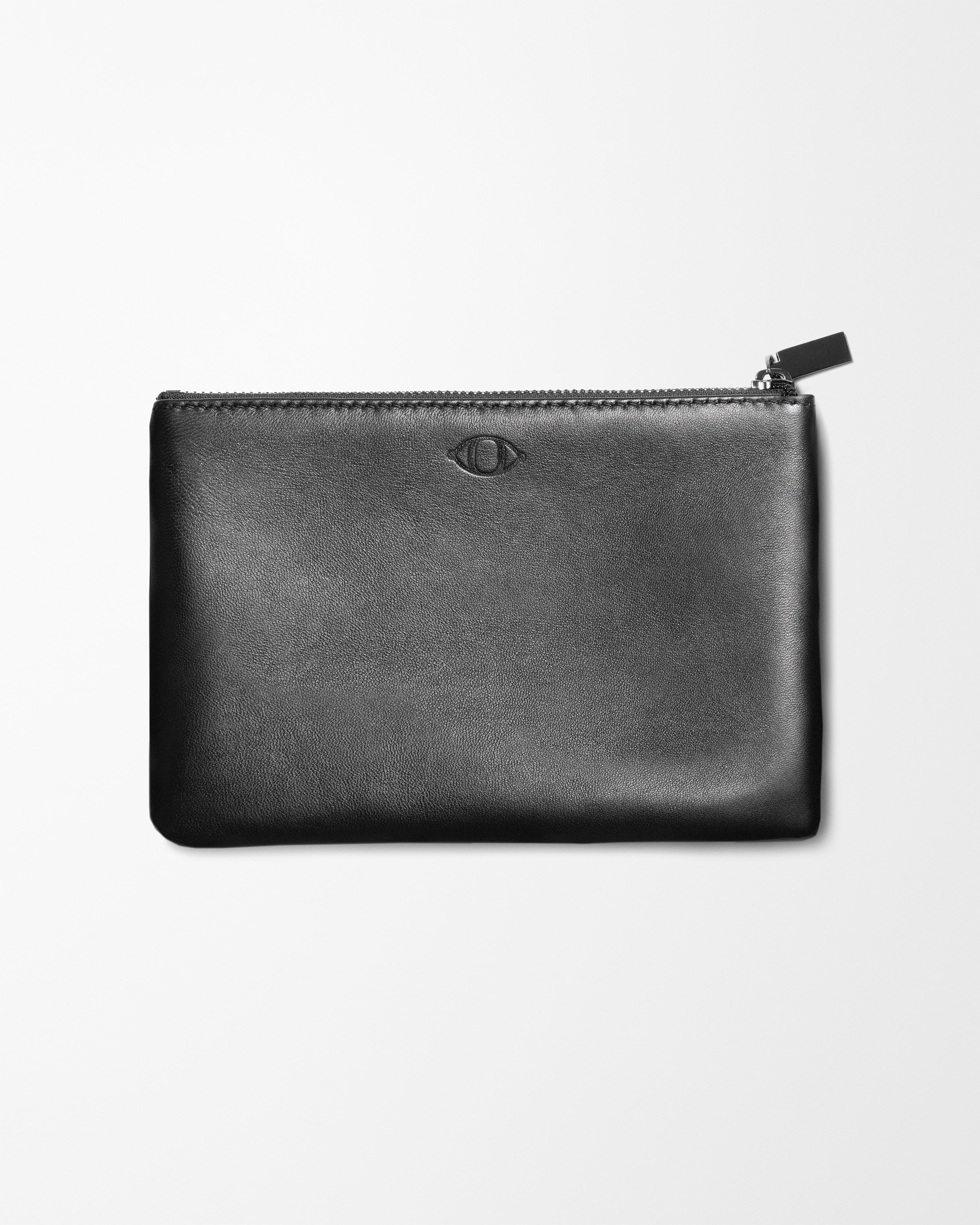 Black leather pouch laying on grey background