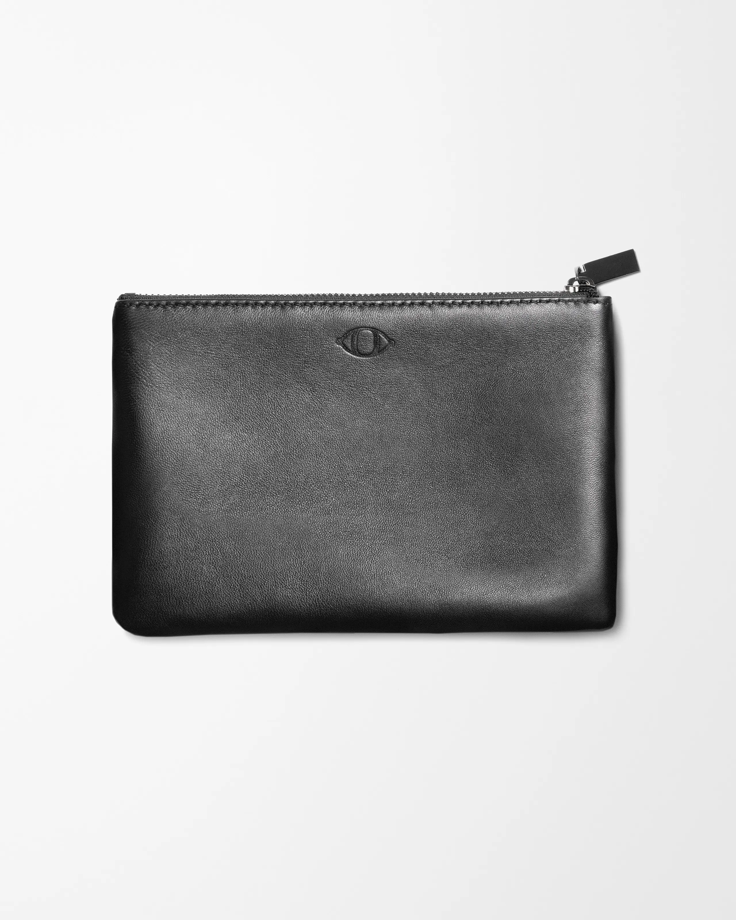 Black leather pouch laying on grey background