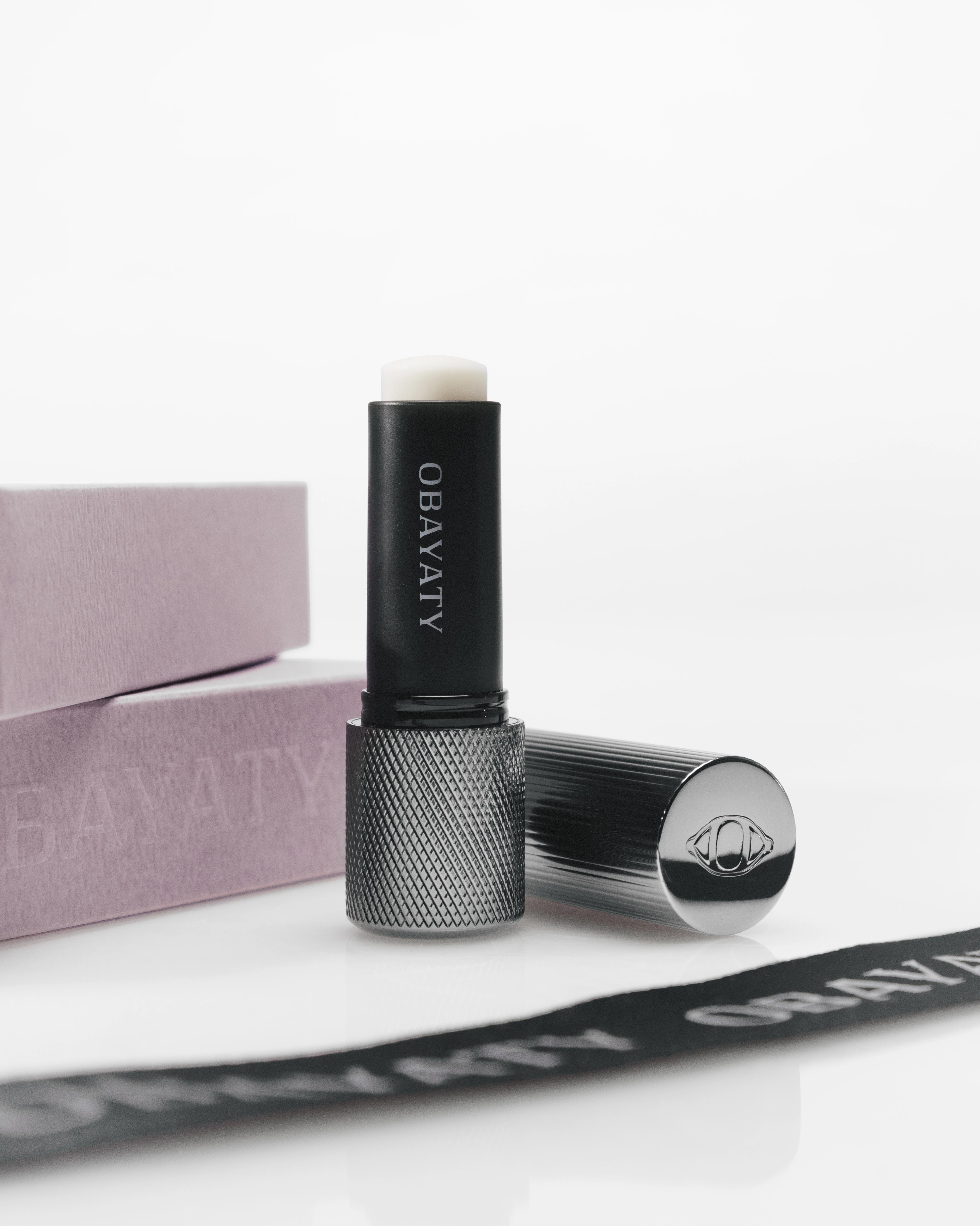 Men's lip balm laying on a grey surface