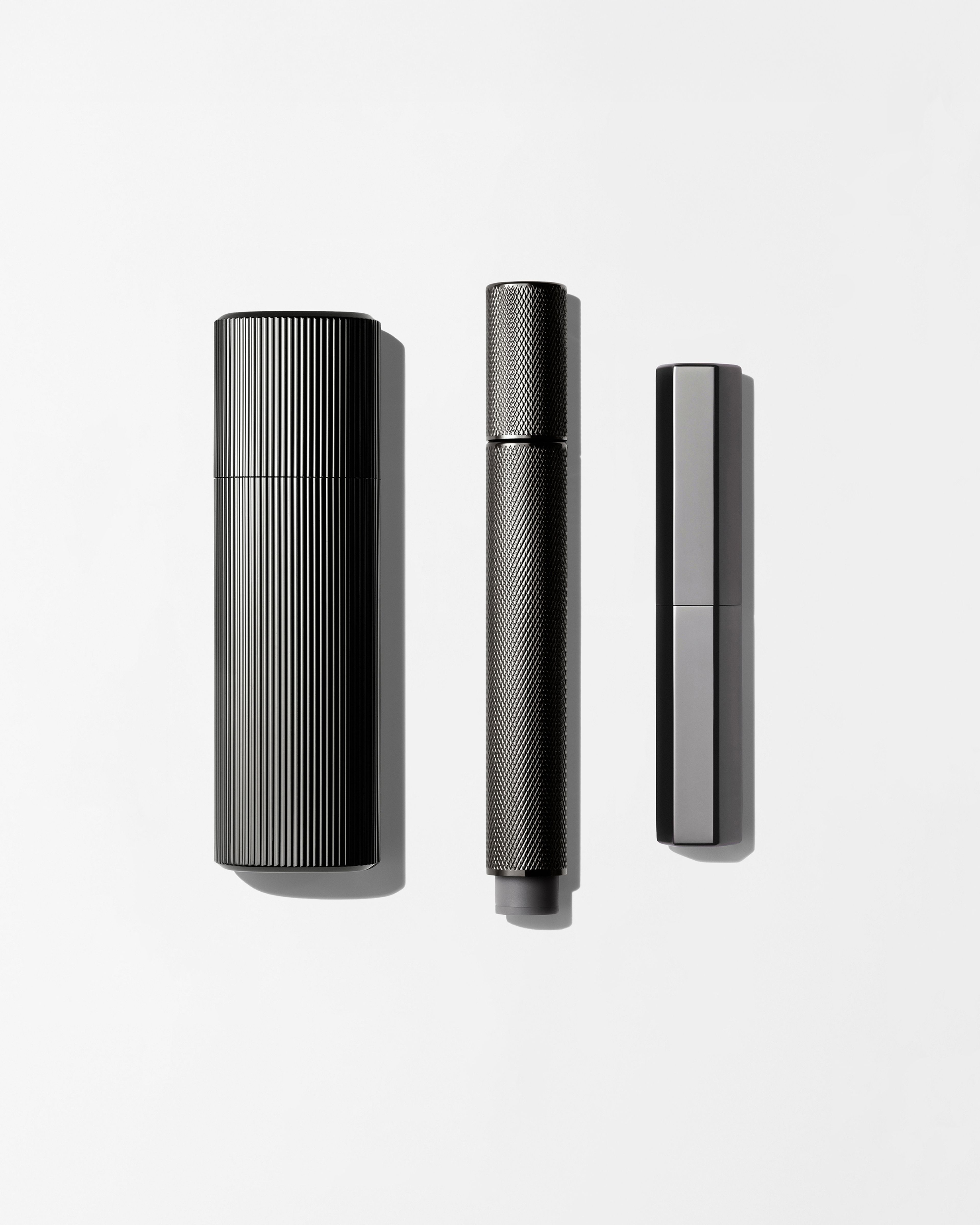 Men's make up kit laying on a grey background