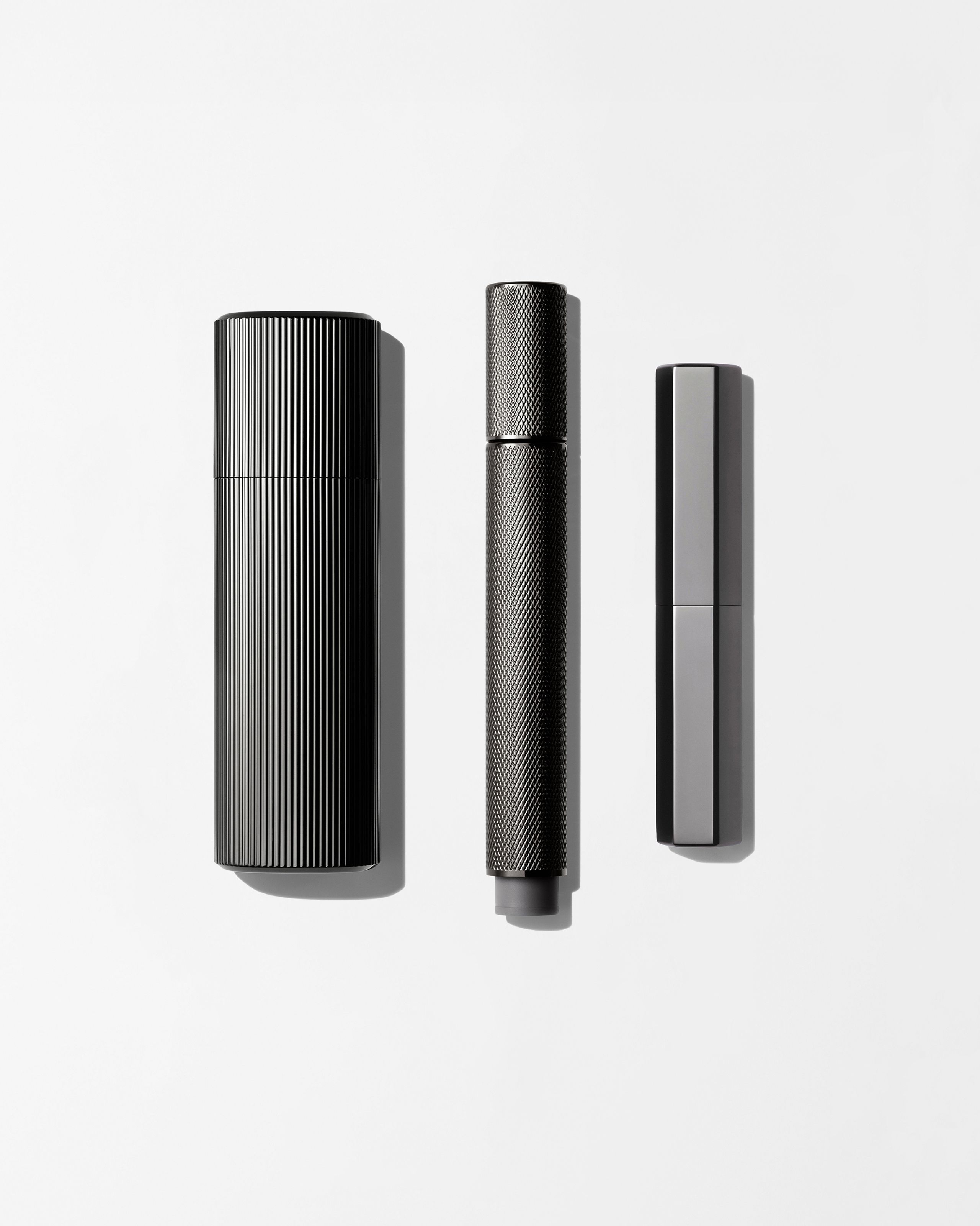 Men's make up kit laying on a grey background