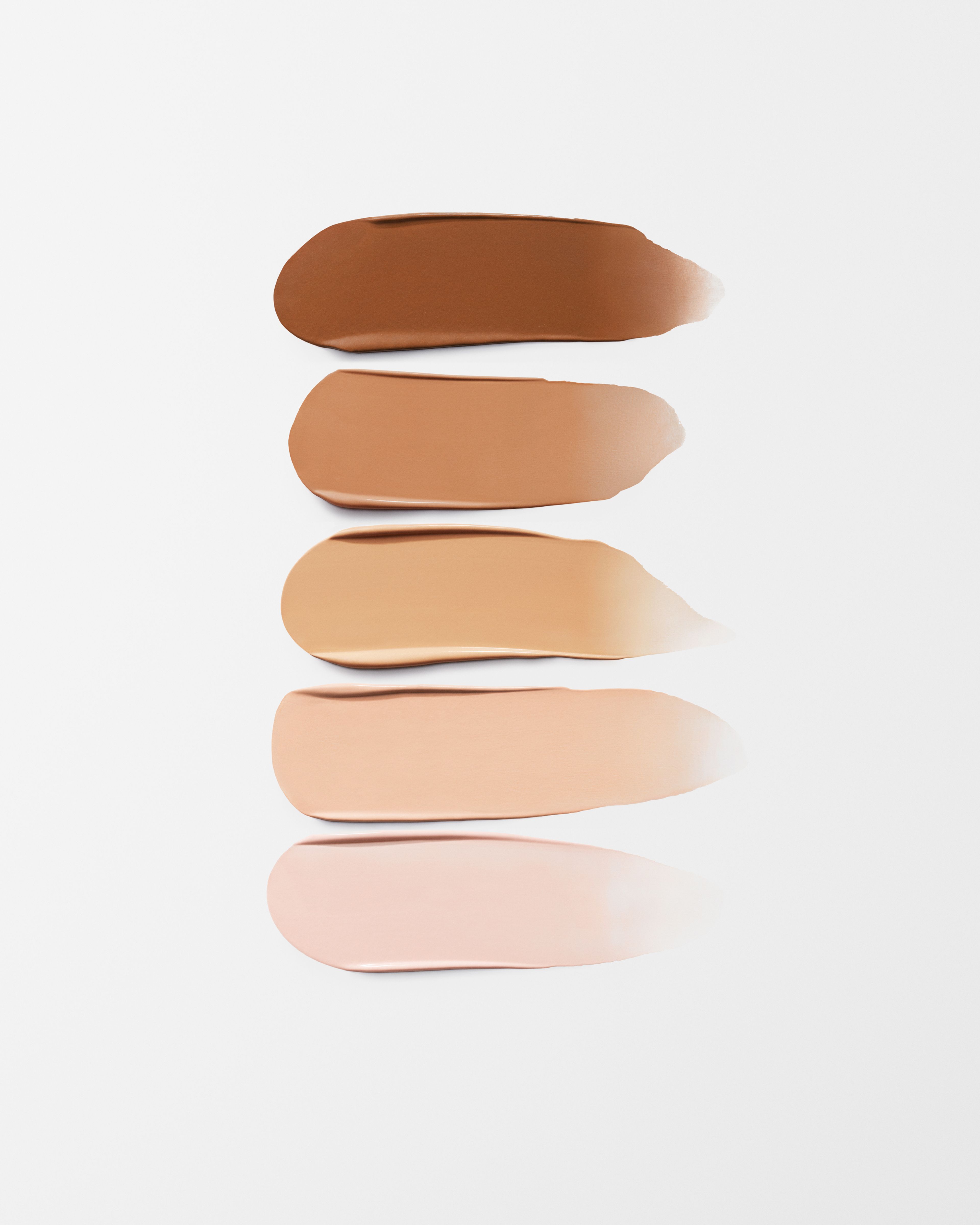 Tinted eye cream Refill laying on a grey surface