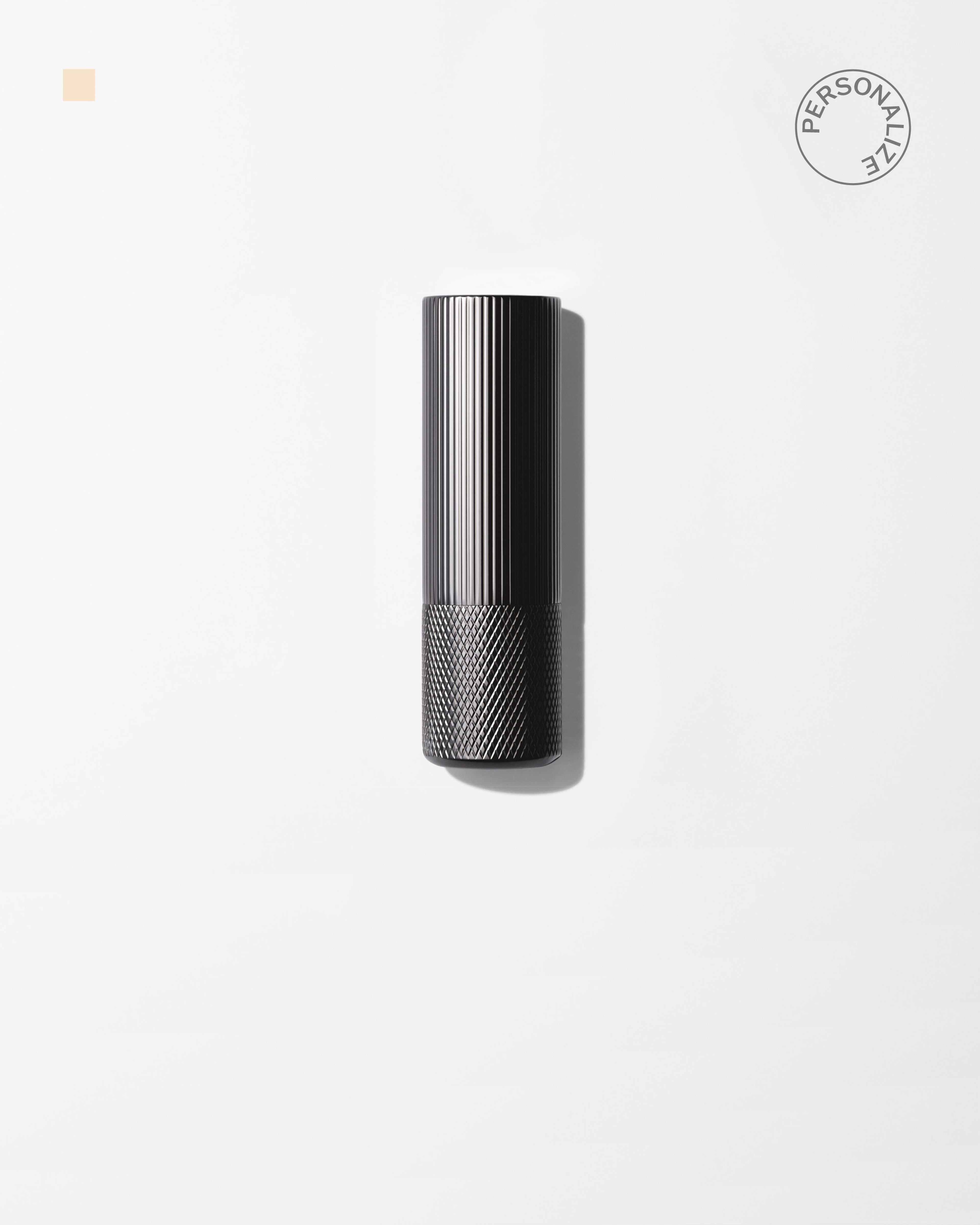 Soothing Lip Balm laying on a grey surface