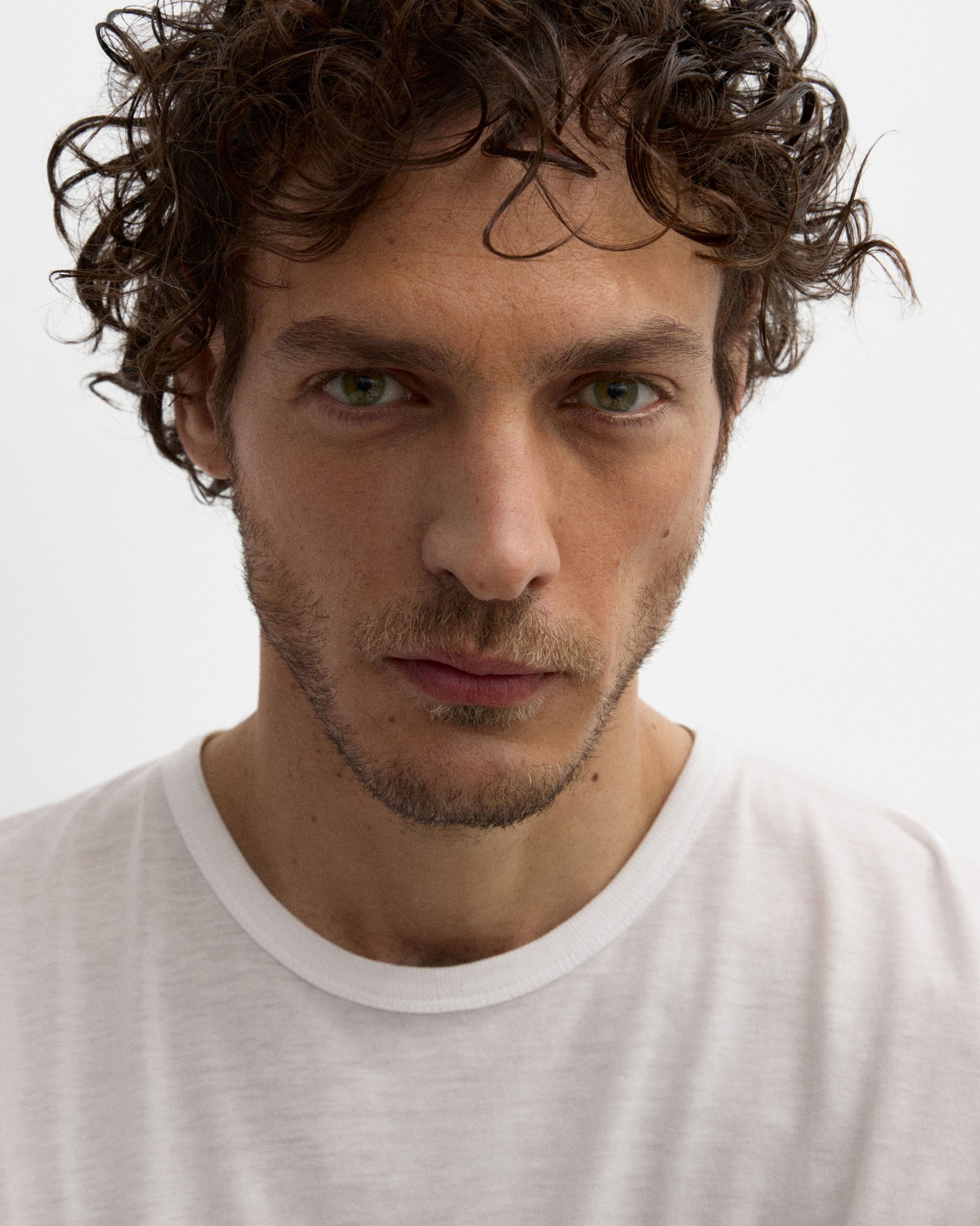 Man looking into the camera with tinted eye cream applied