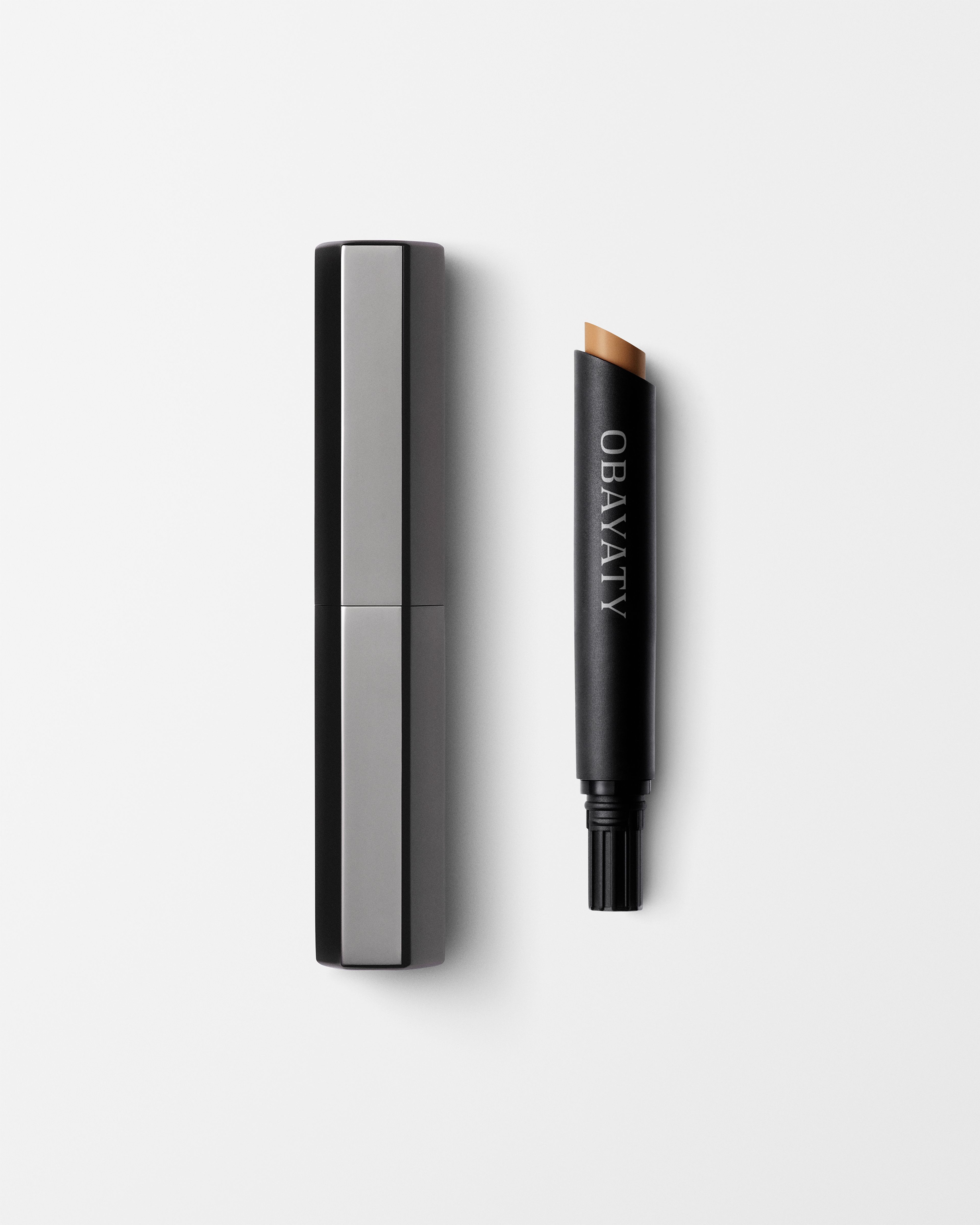 Concealer for men laying on a grey surface