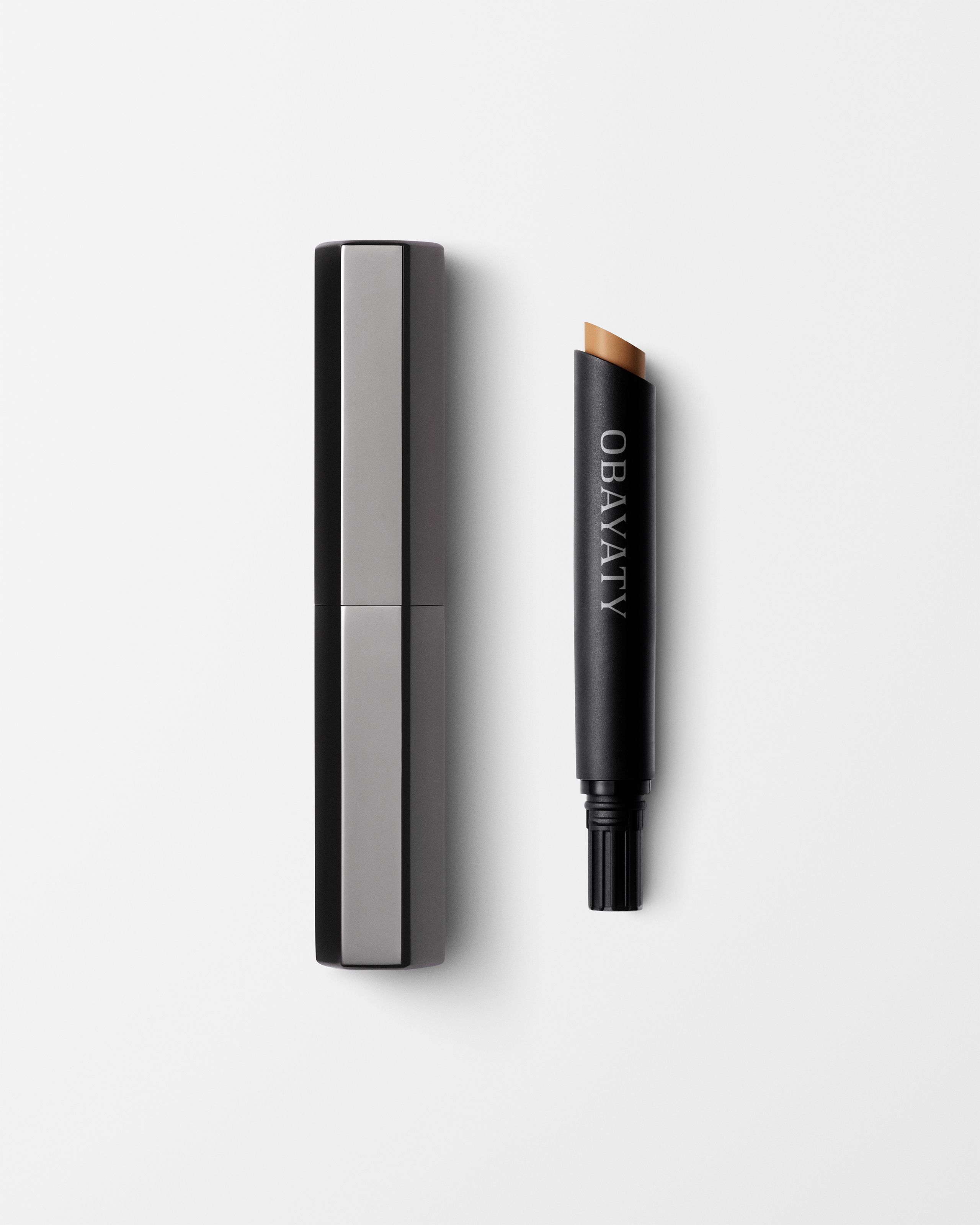 Concealer for men laying on a grey surface