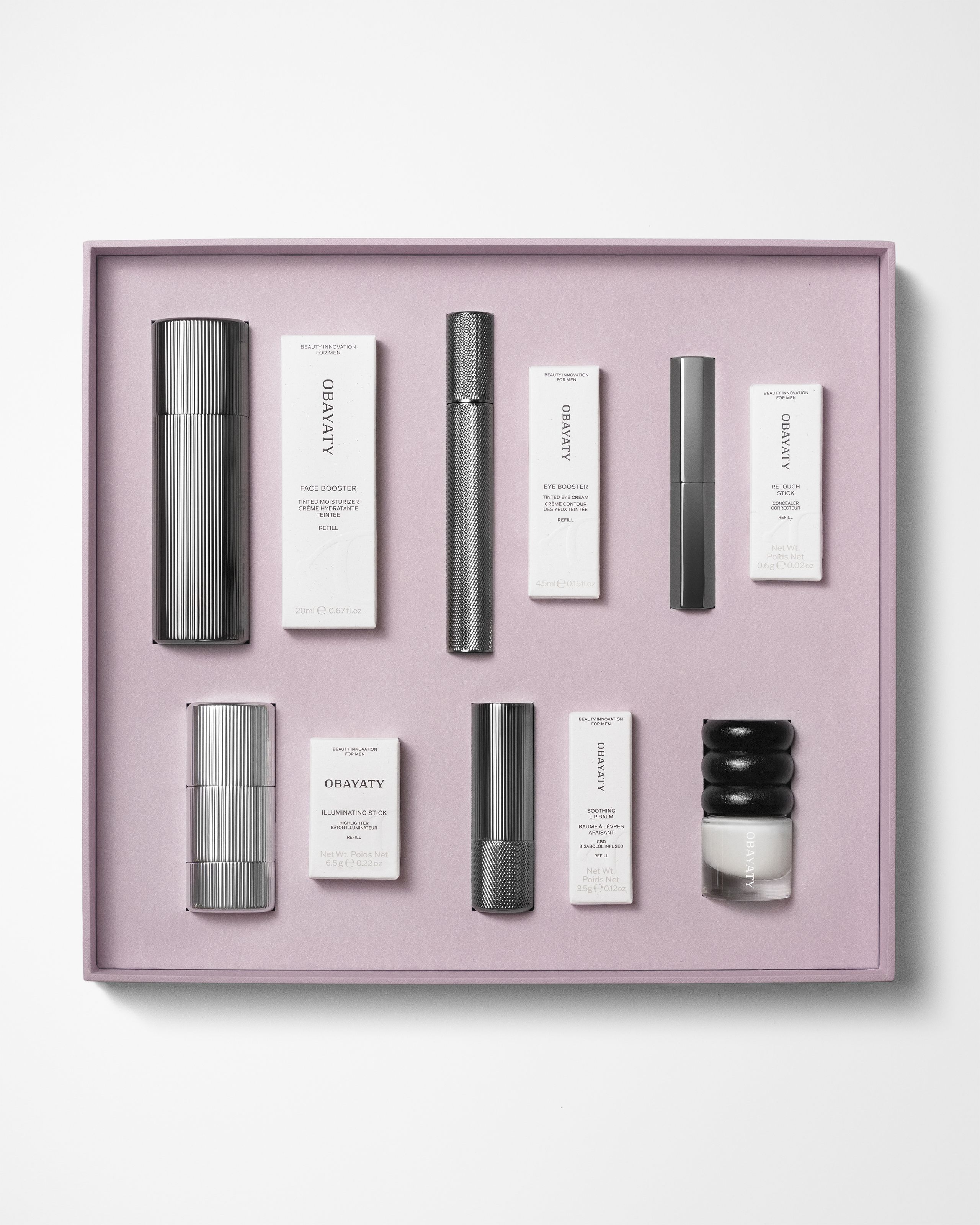 Make up kit for men laying on a grey background