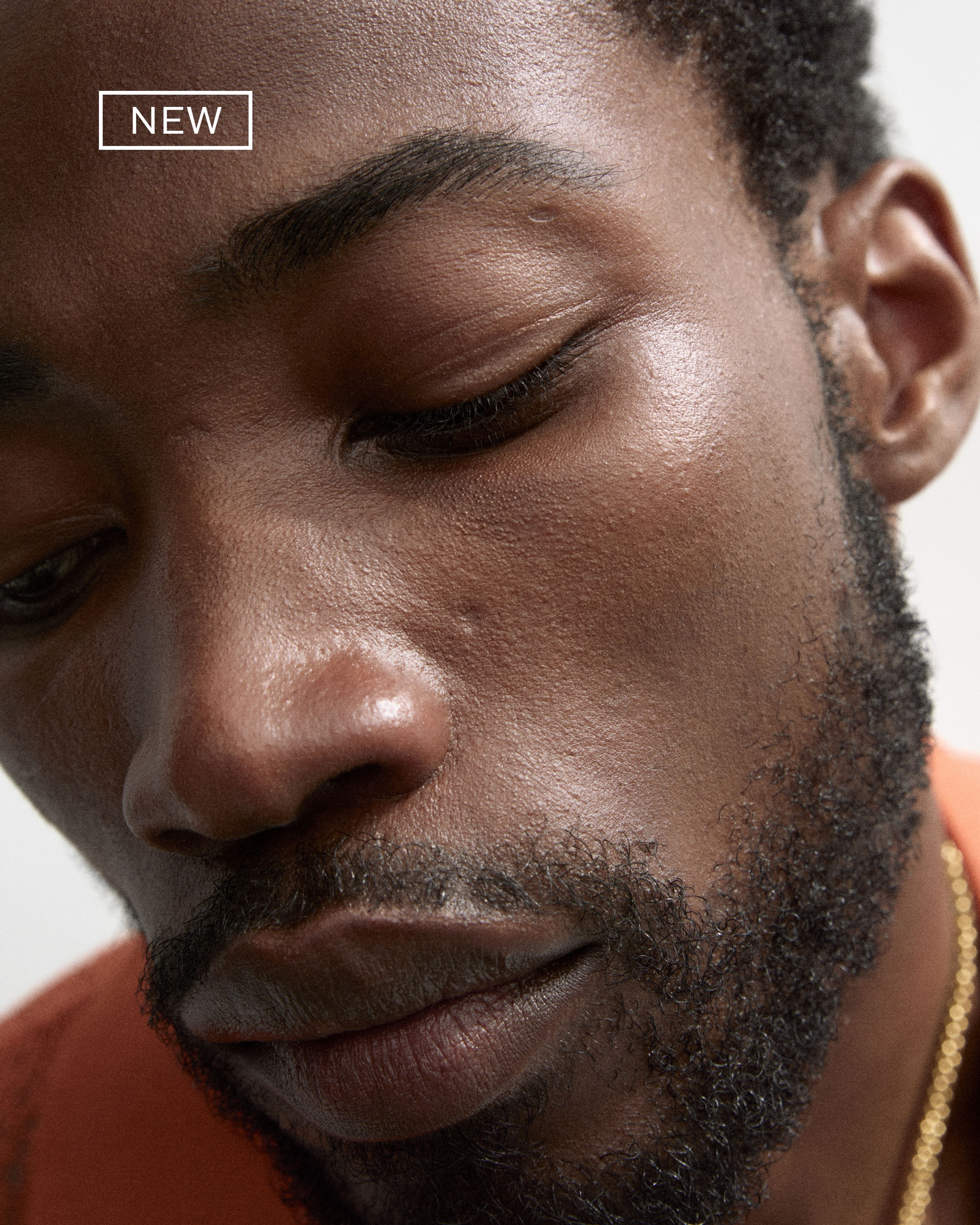 Men's brow beard pen laying on a grey surface