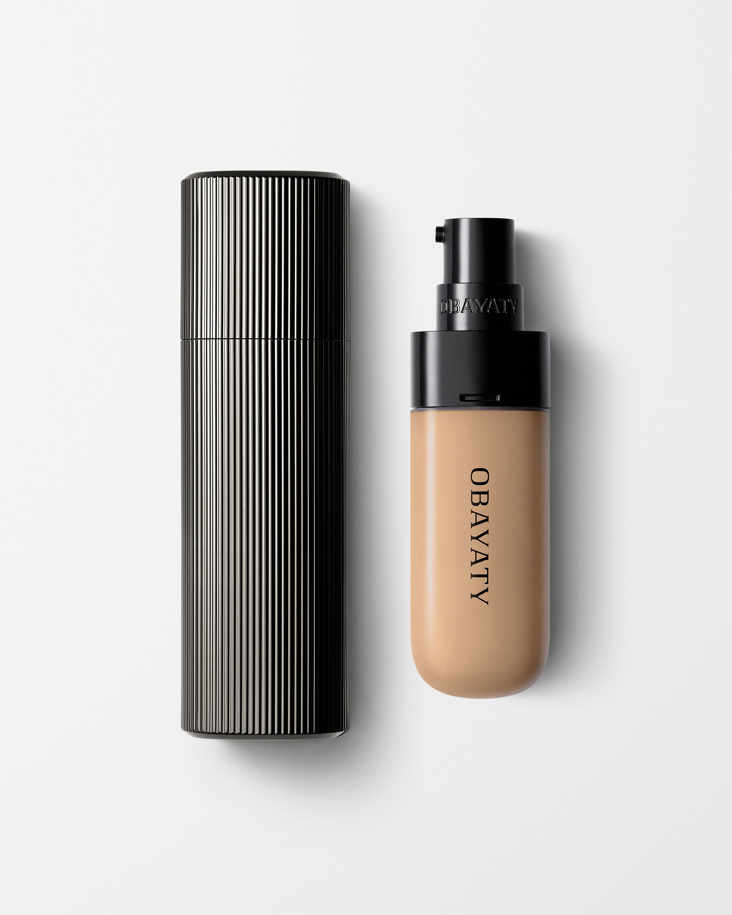 Tinted Moisturizer for men laying on a grey surface