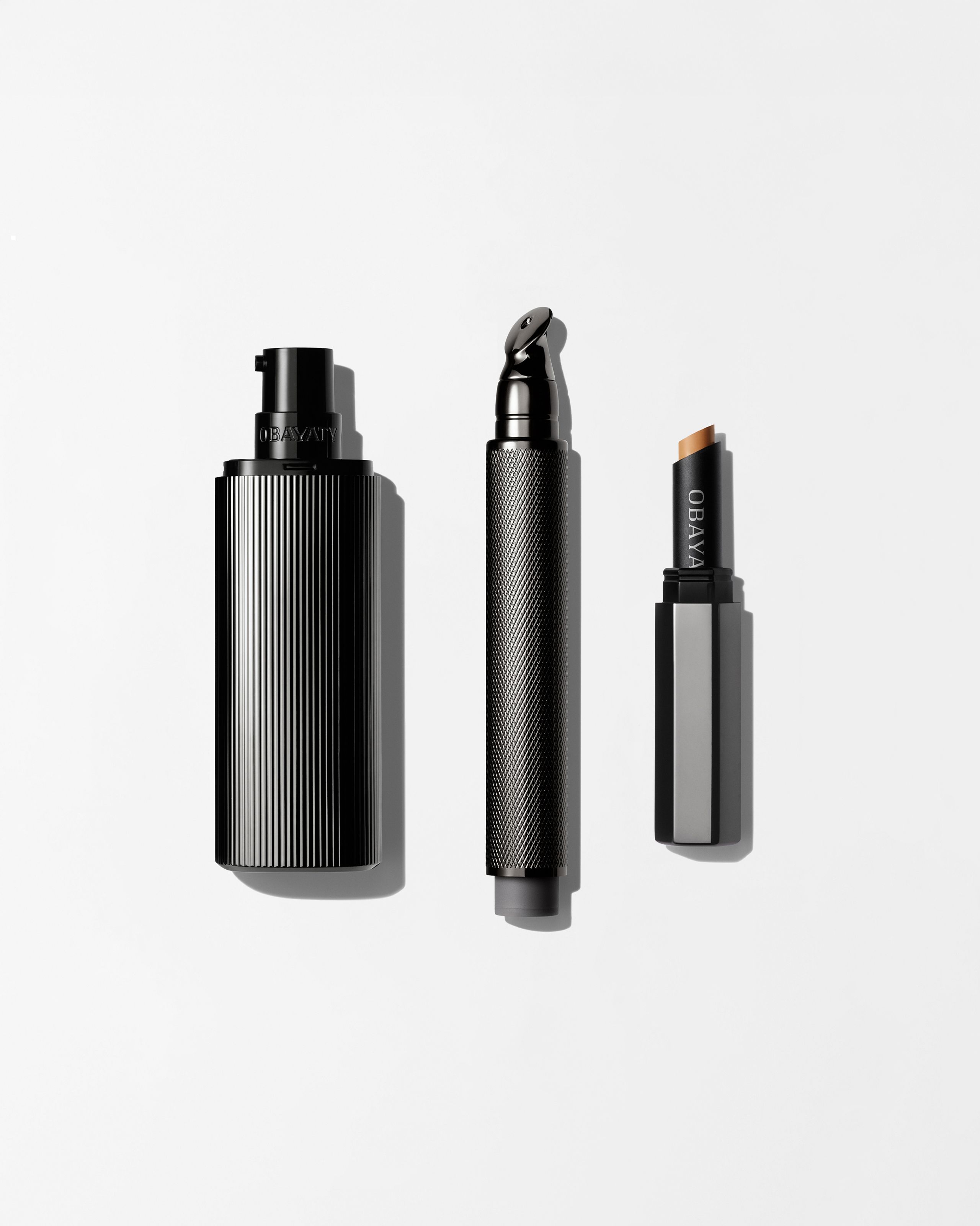 Men's Concealer, Tinted Moisturizer and Tinted Eye Cream Laying on a grey surface