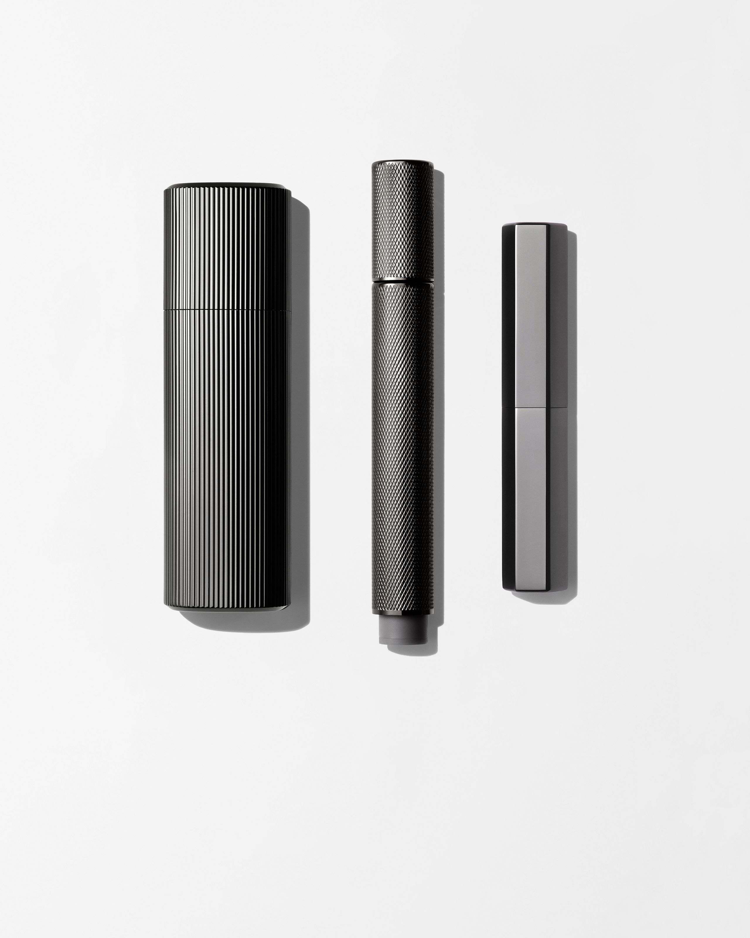 Men's make up kit laying on a grey background