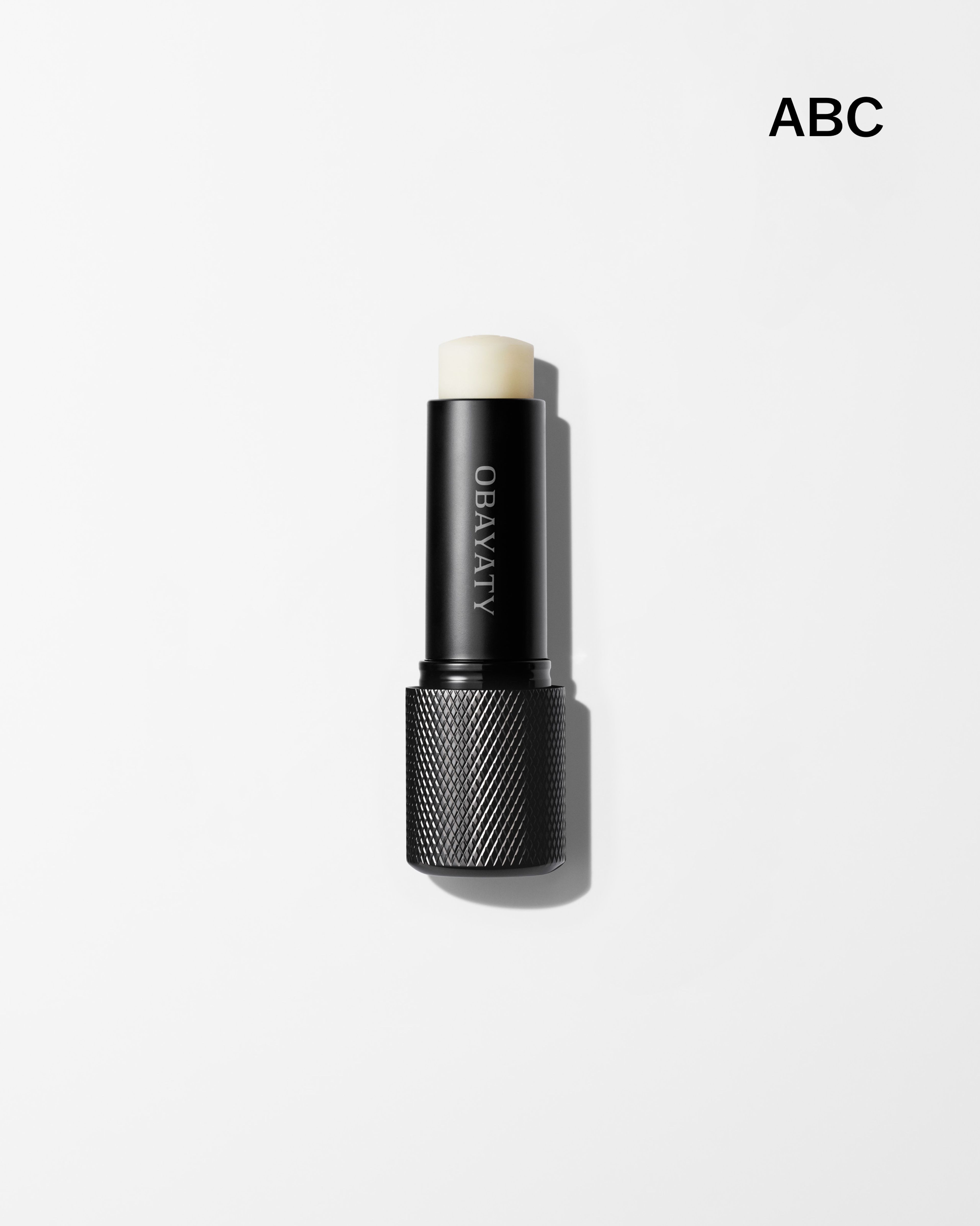 Mens lip balm laying on a grey surface