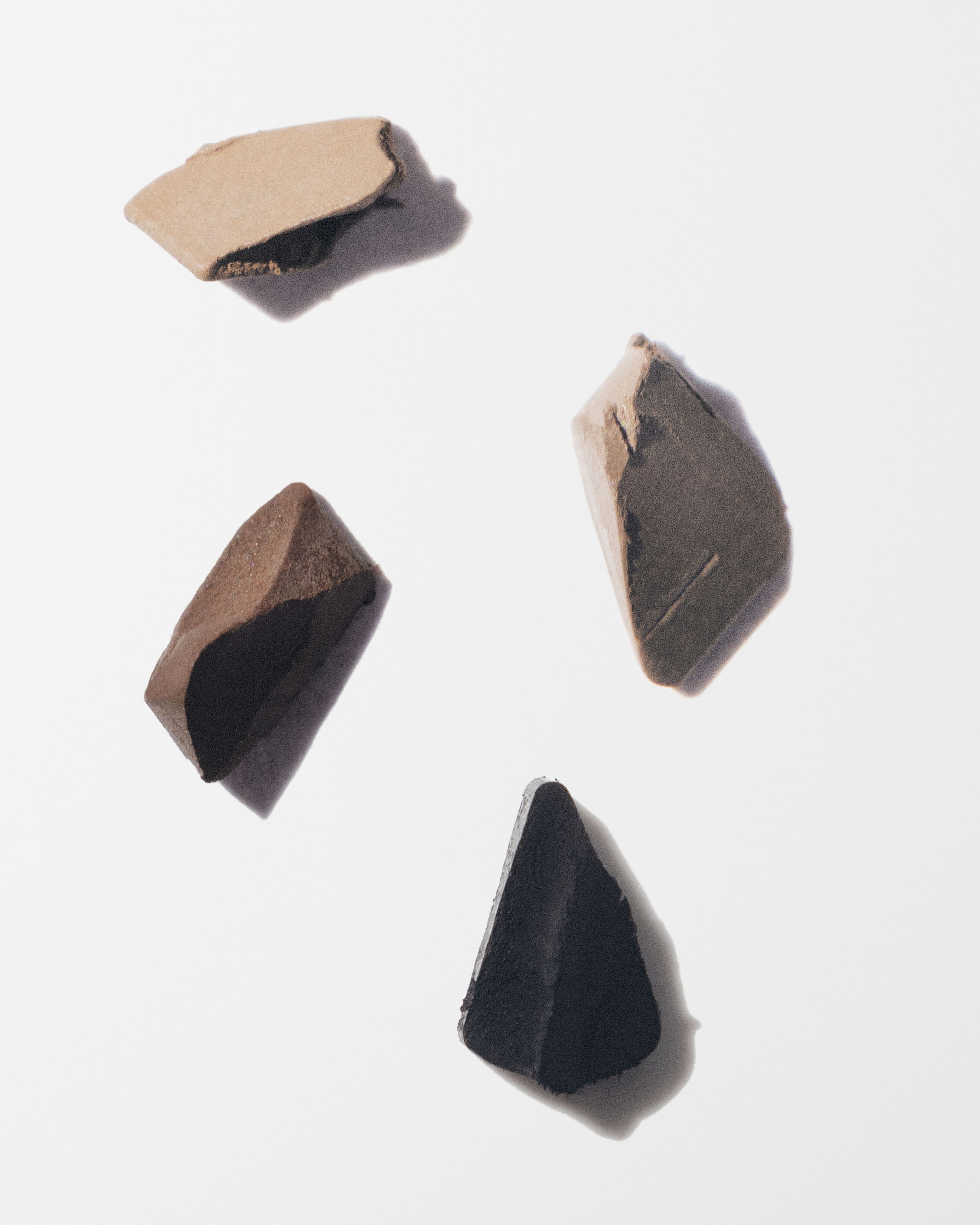 Brow Beard Pen swatches in four shades on a grey surface
