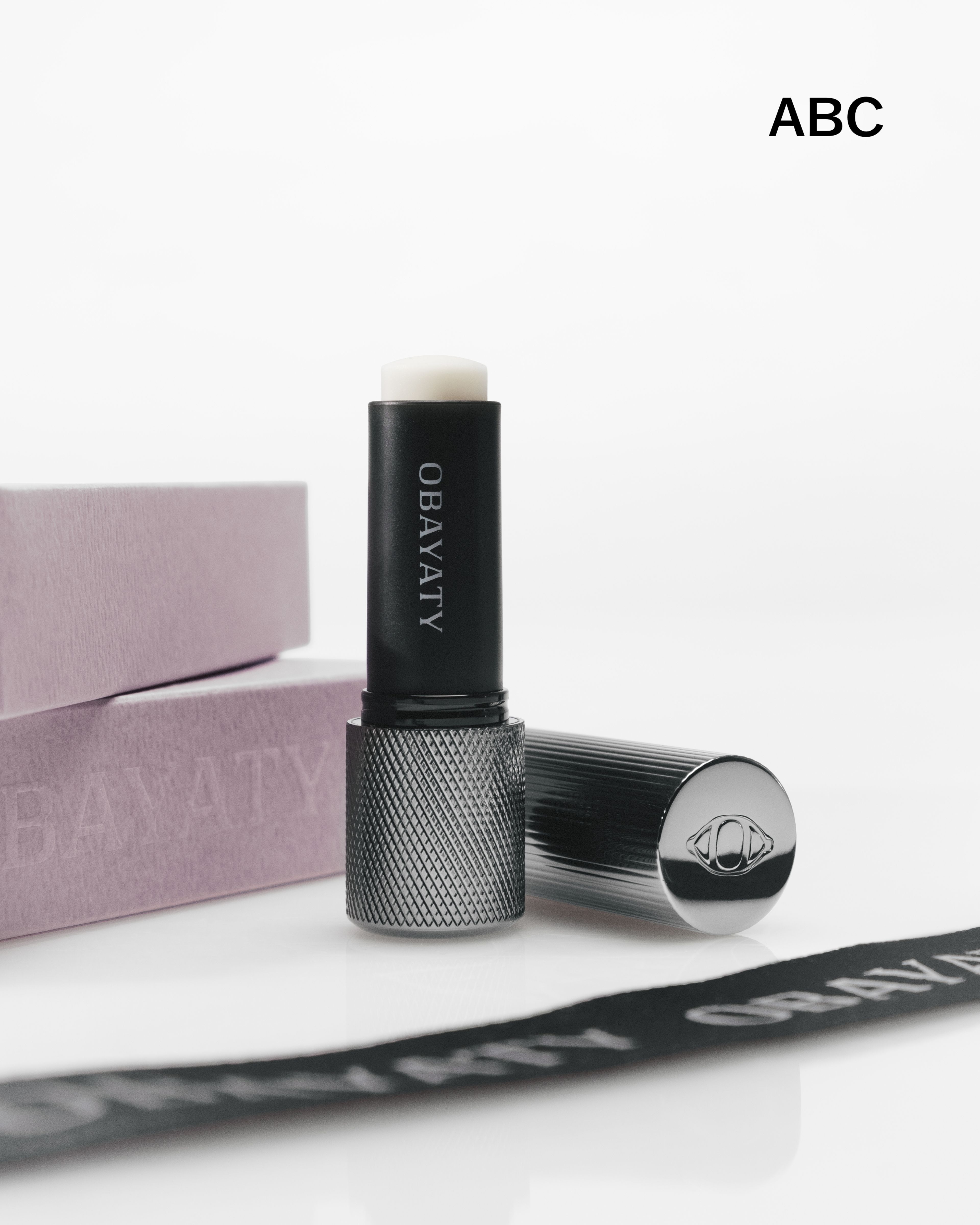 Men's lip balm laying on a grey surface