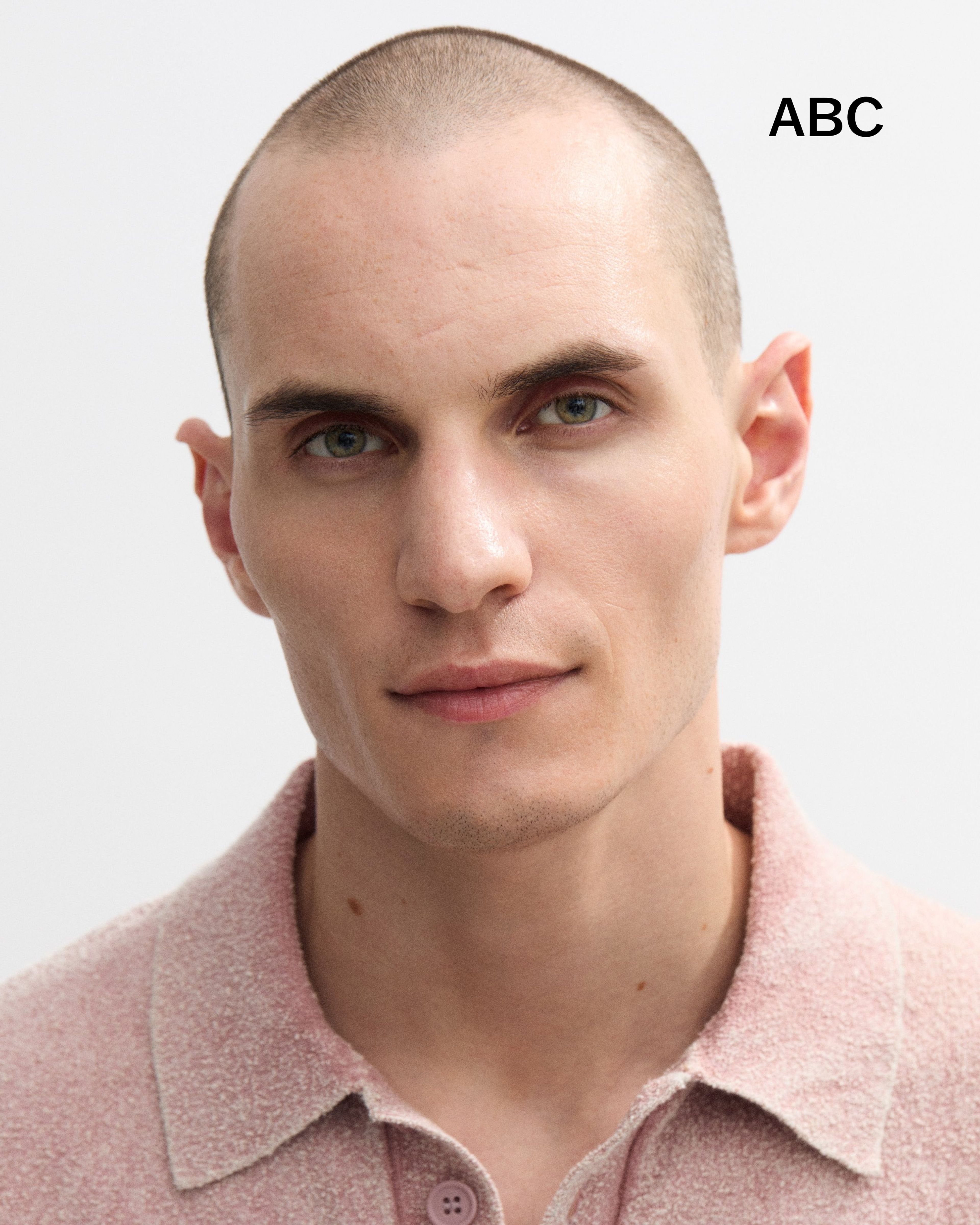 A men's lip balm laying on a grey surface.