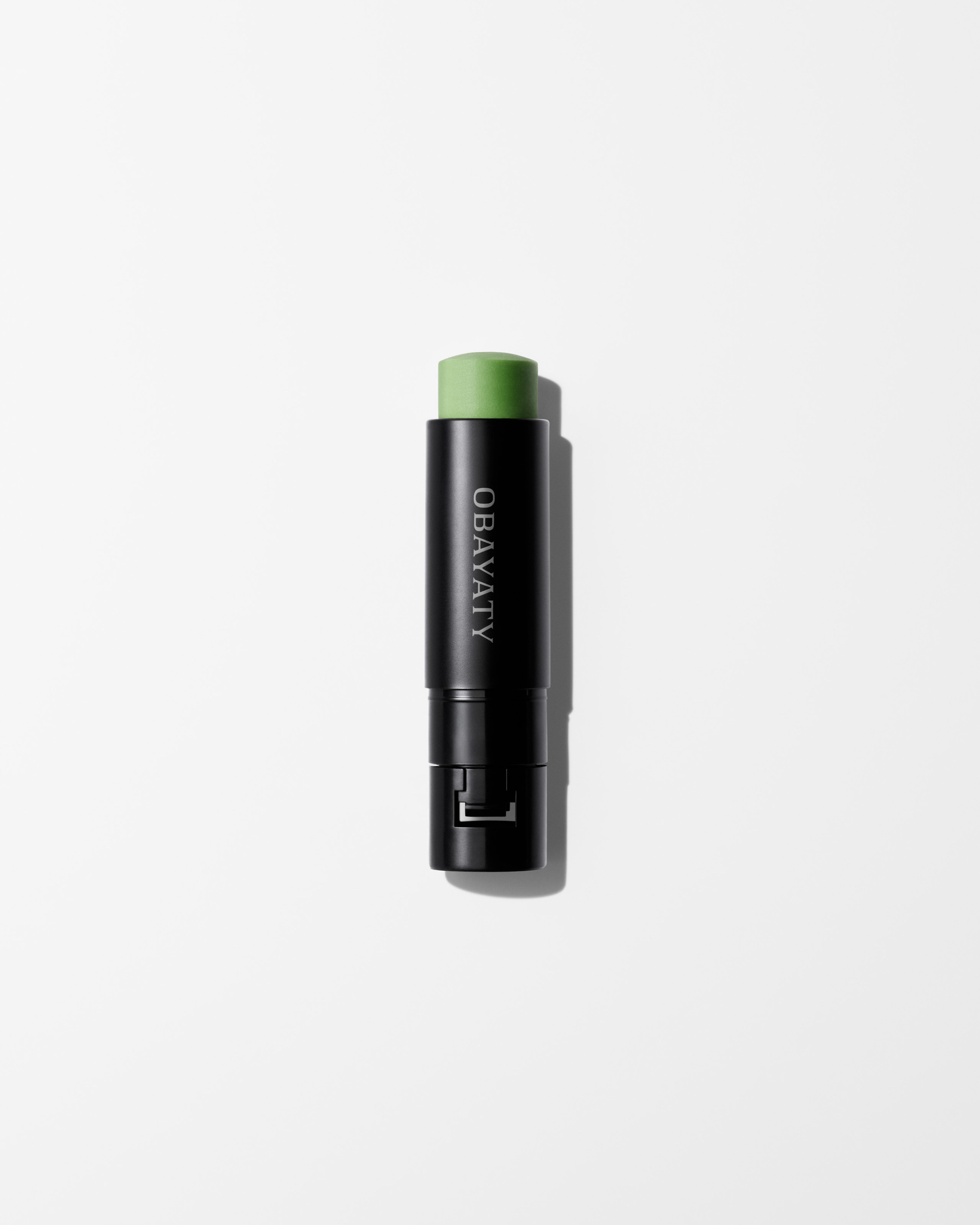Anti-Rouge Lip Balm refill laying on a grey surface