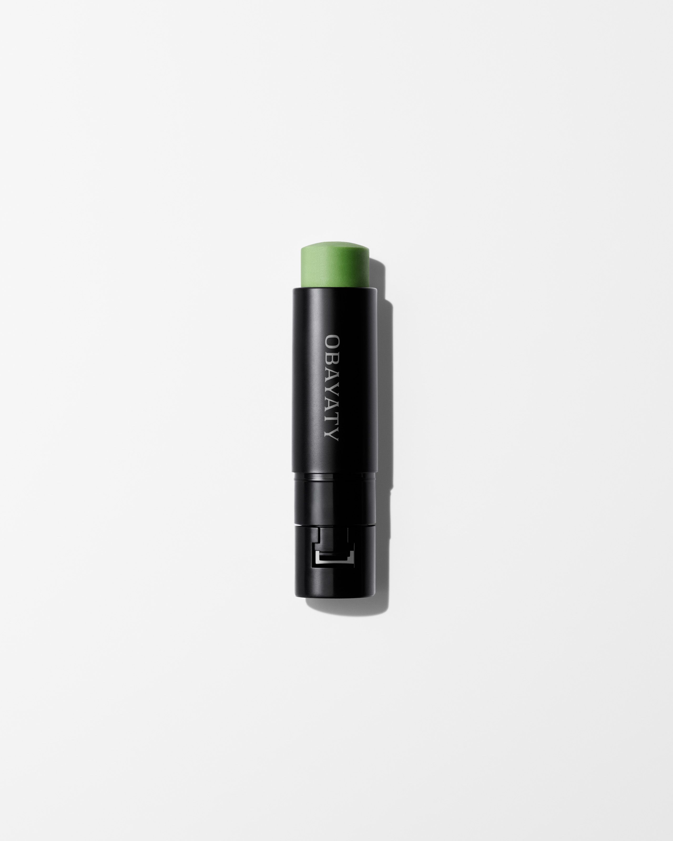 Anti-Rouge Lip Balm refill laying on a grey surface