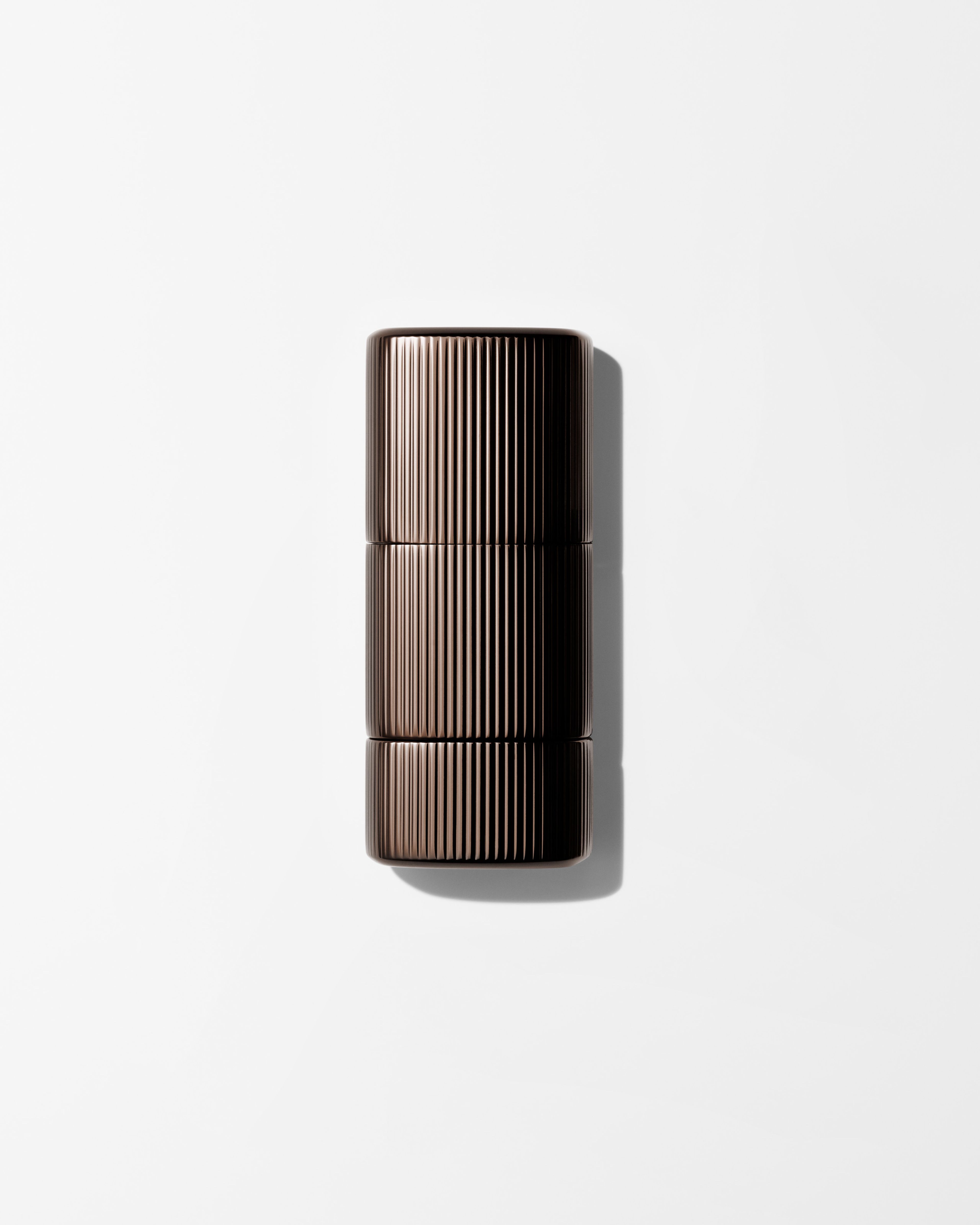 Bronzer for men laying on a grey surface