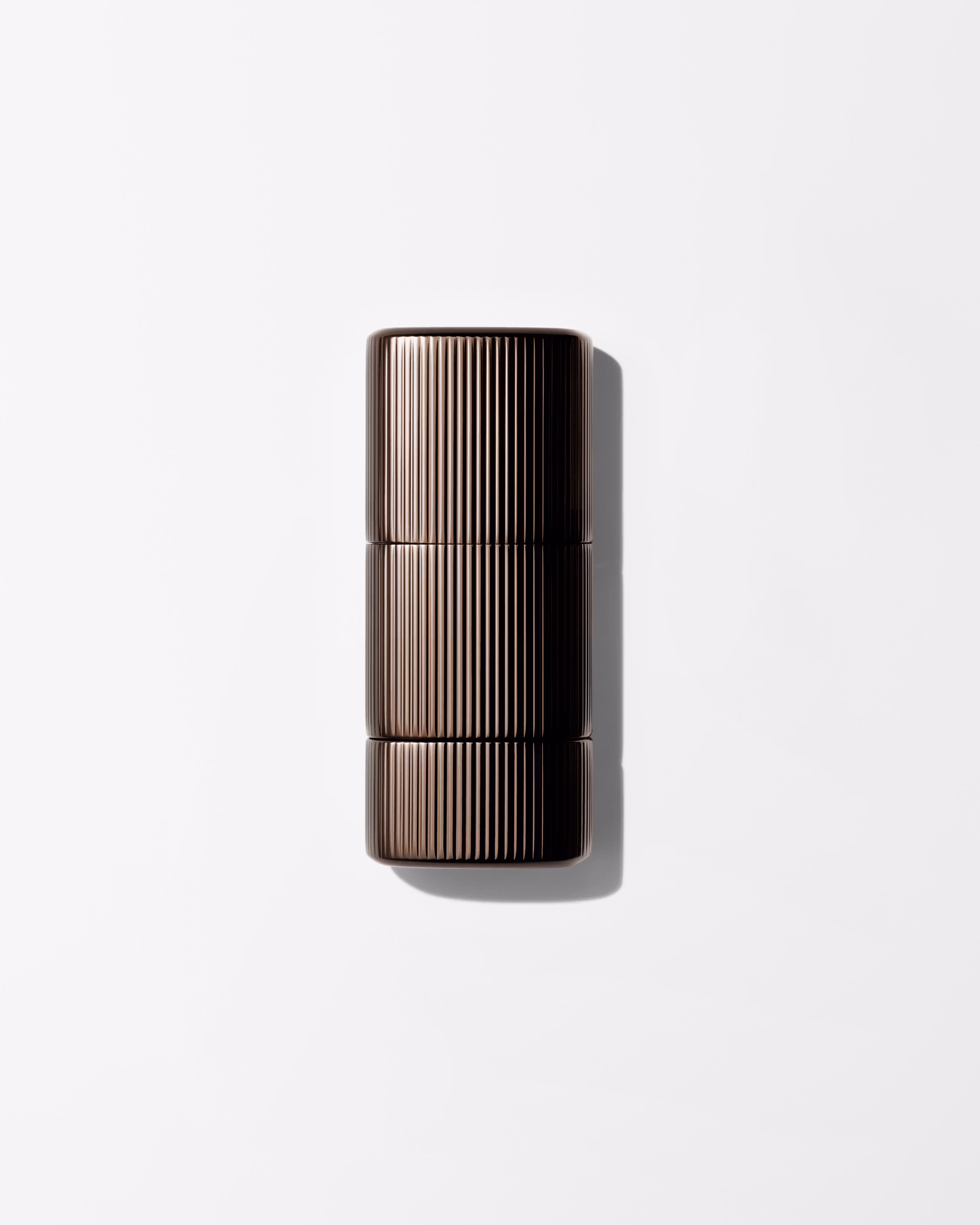 Bronzer for men laying on a grey surface