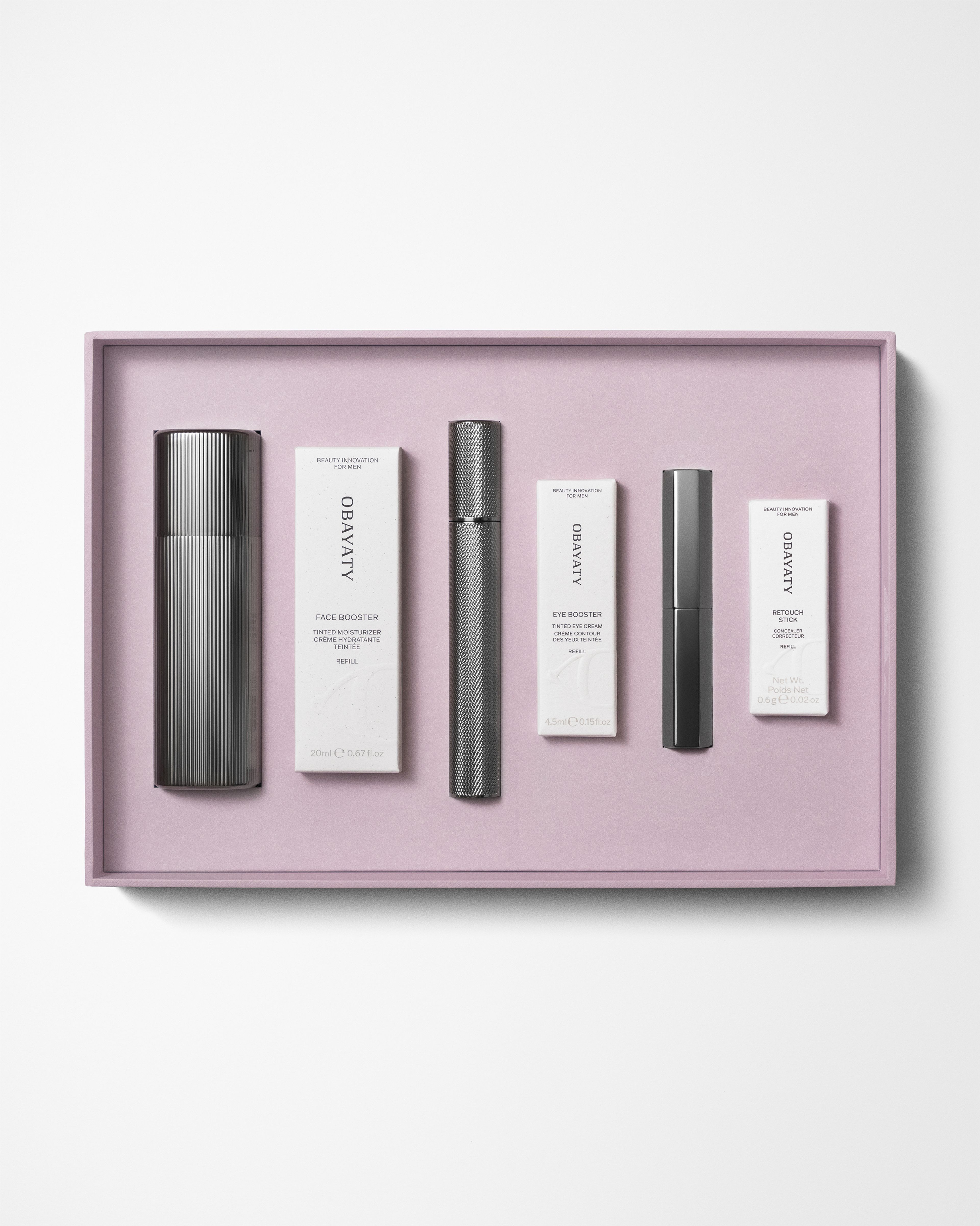 Make up kit for men laying on a grey background