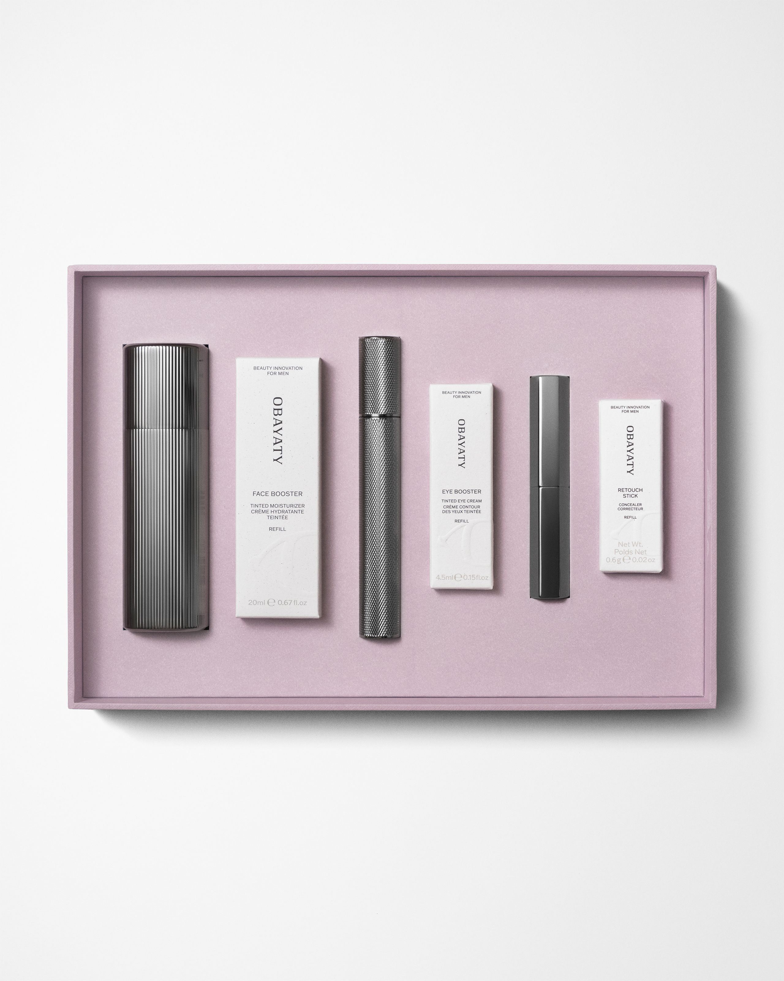 Make up kit for men laying on a grey background