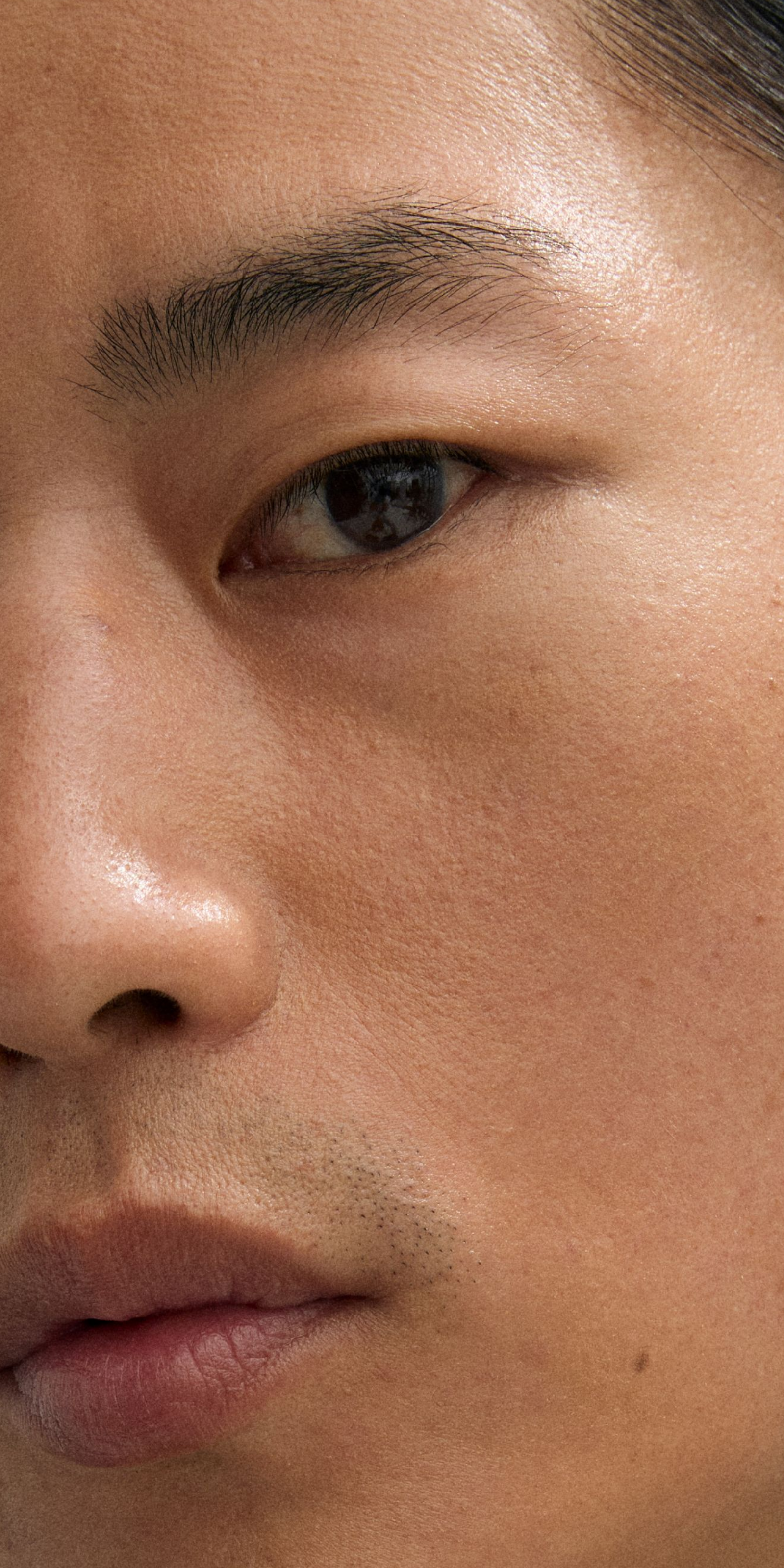 Man looking into the camera with retouch stick applied