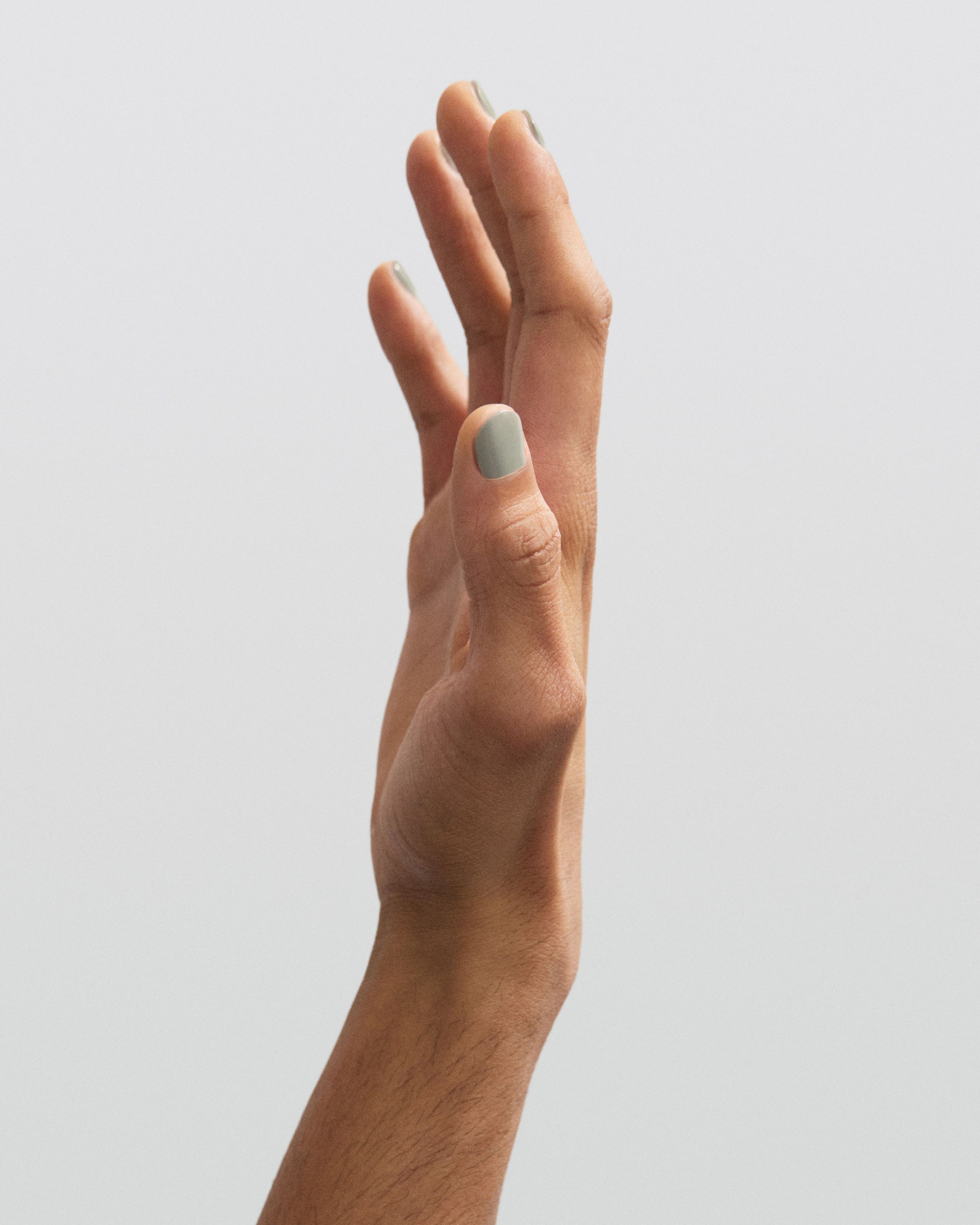 Man holding up his hand with Nail polish Lunar applied