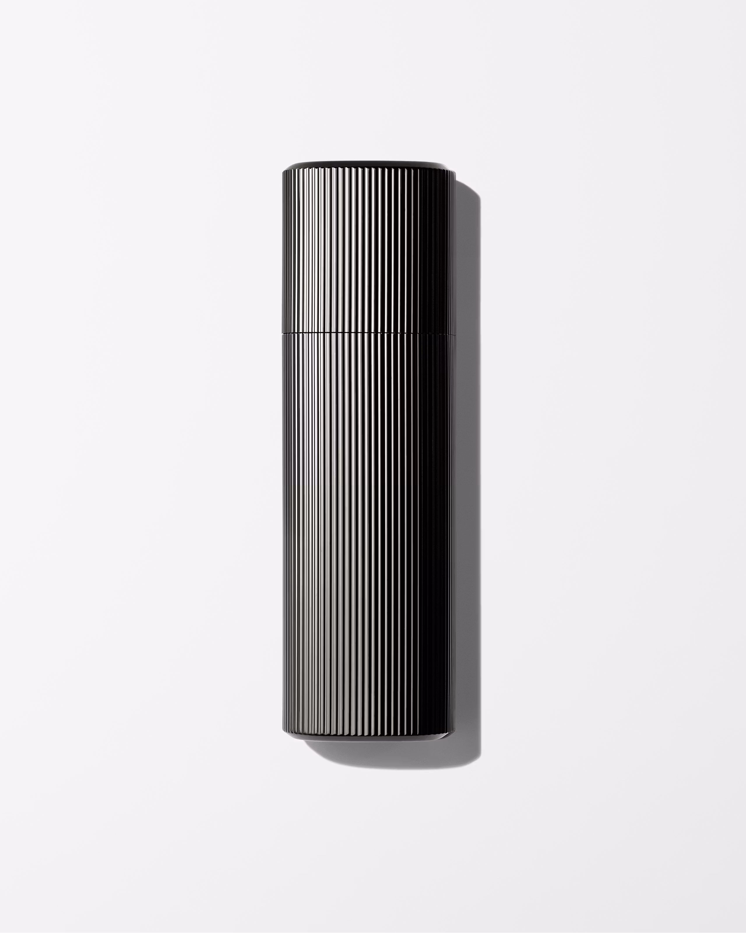 Men's tinted moisturizer laying on a grey surface