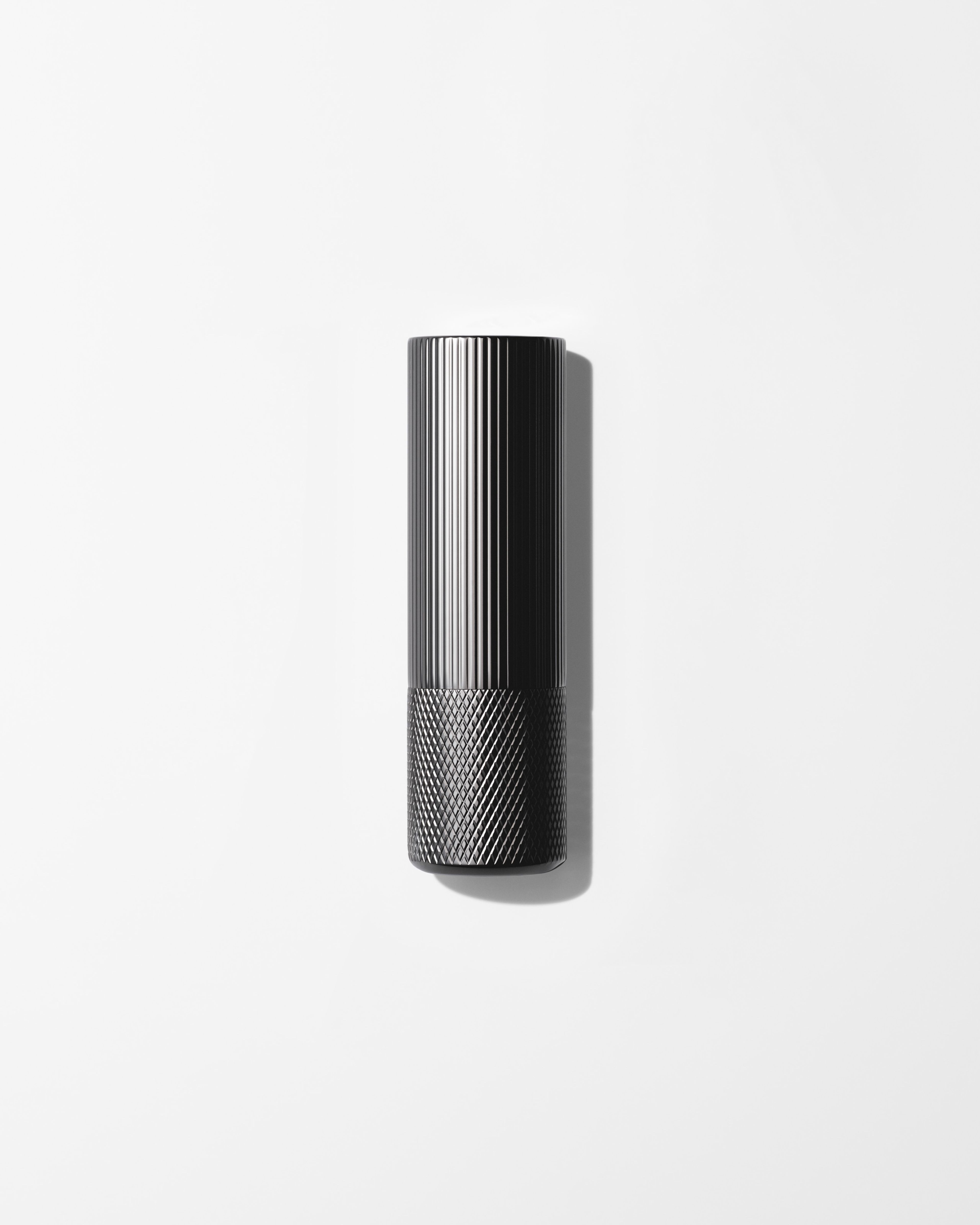 Soothing Lip Balm laying on a grey surface