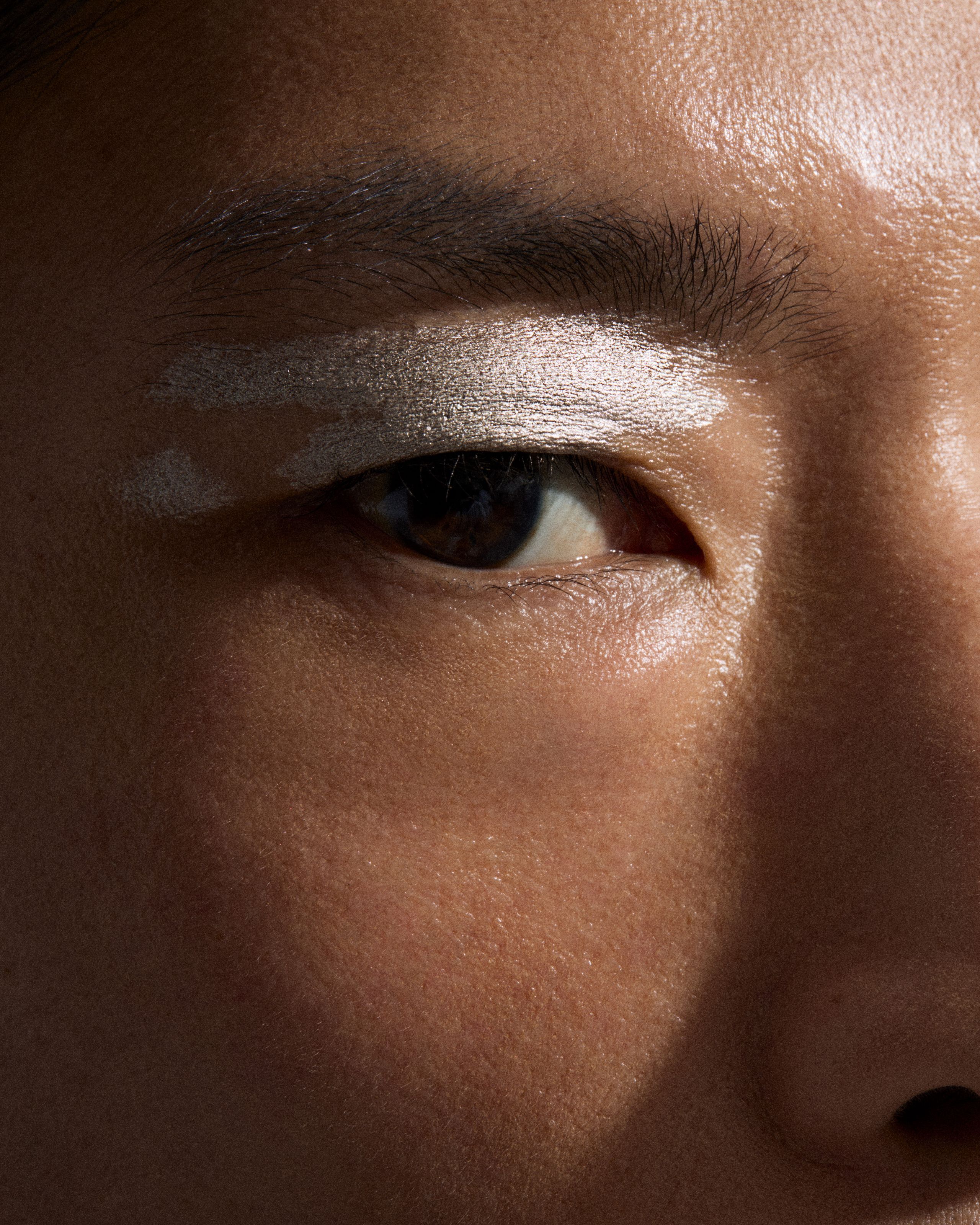 Close up of a mans eye with silver eye pen applied